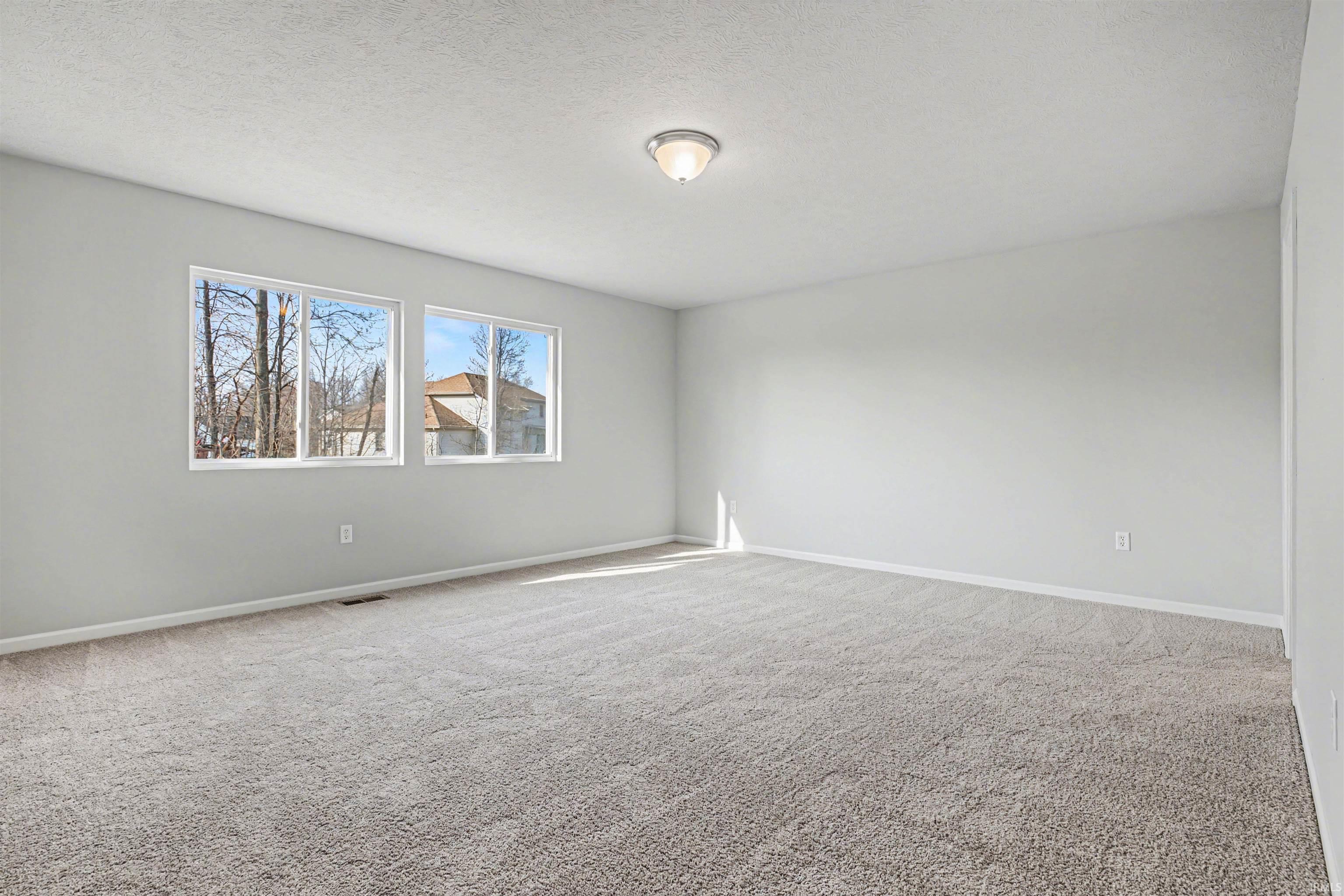 The spacious primary suite includes a private bath and oversized walk-in closet.