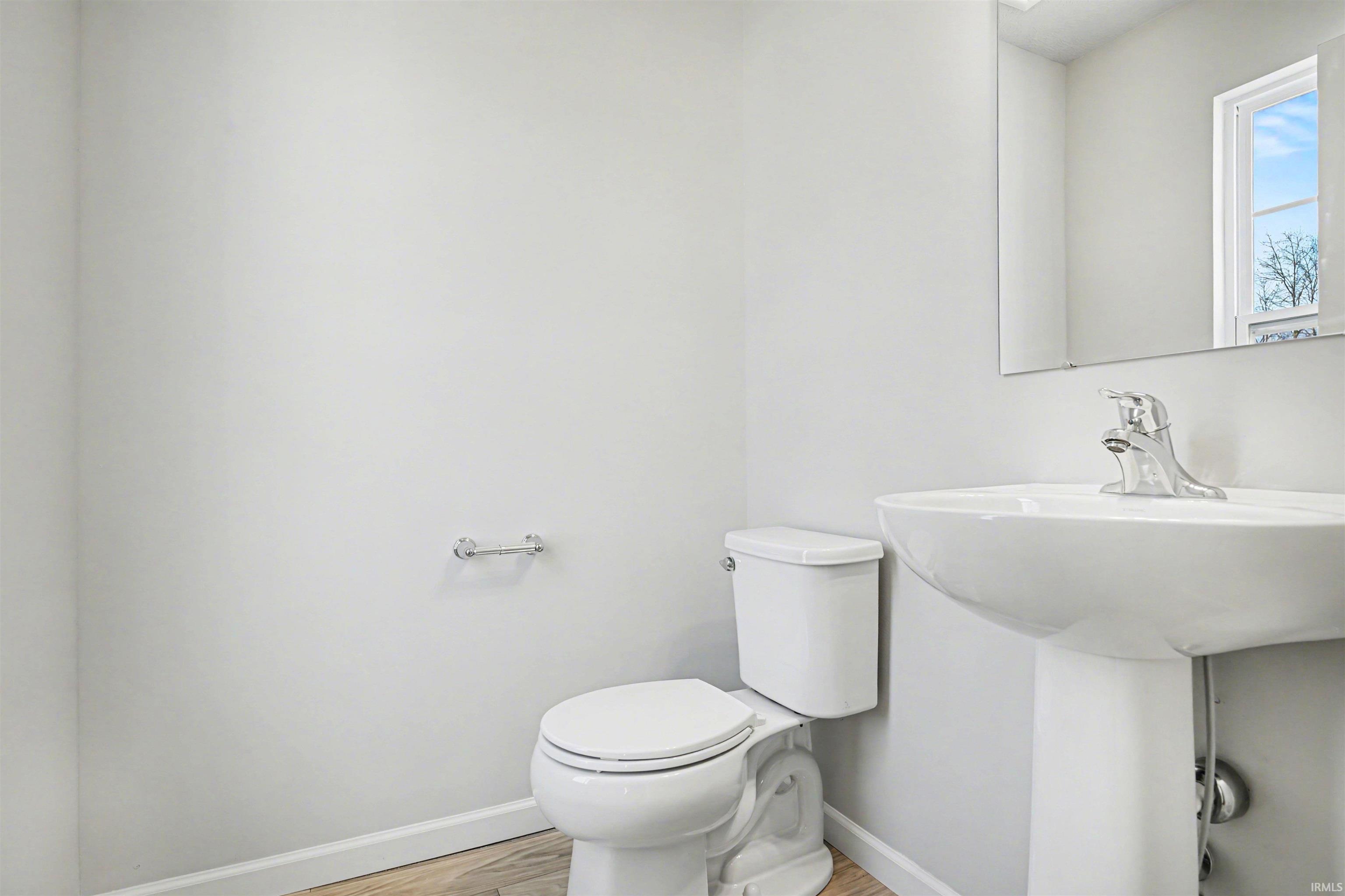 The powder room is located toward the front of the home for privacy.