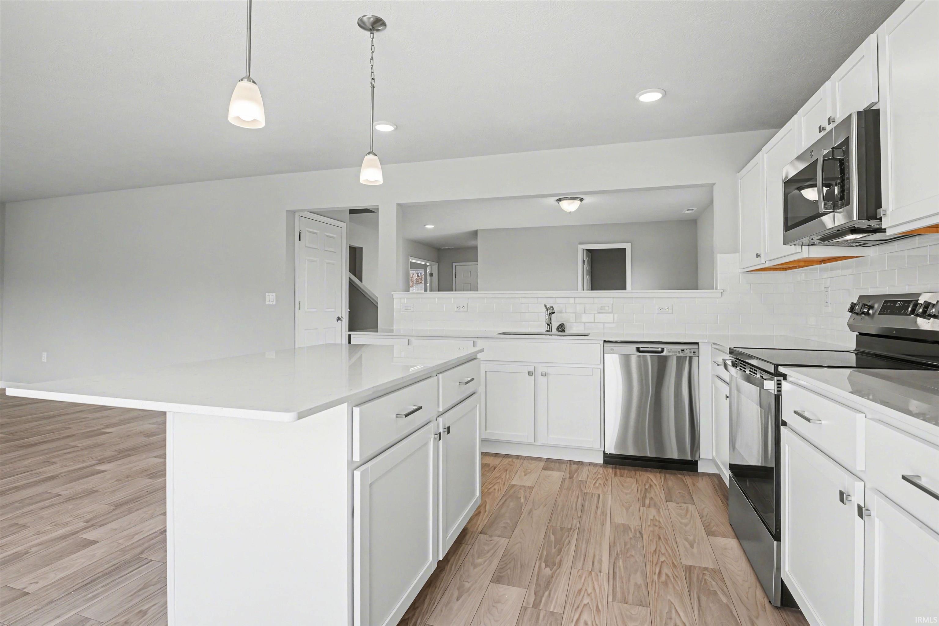 The kitchen offers open sight lines into the great room and consistent flooring allows for a smooth transition.