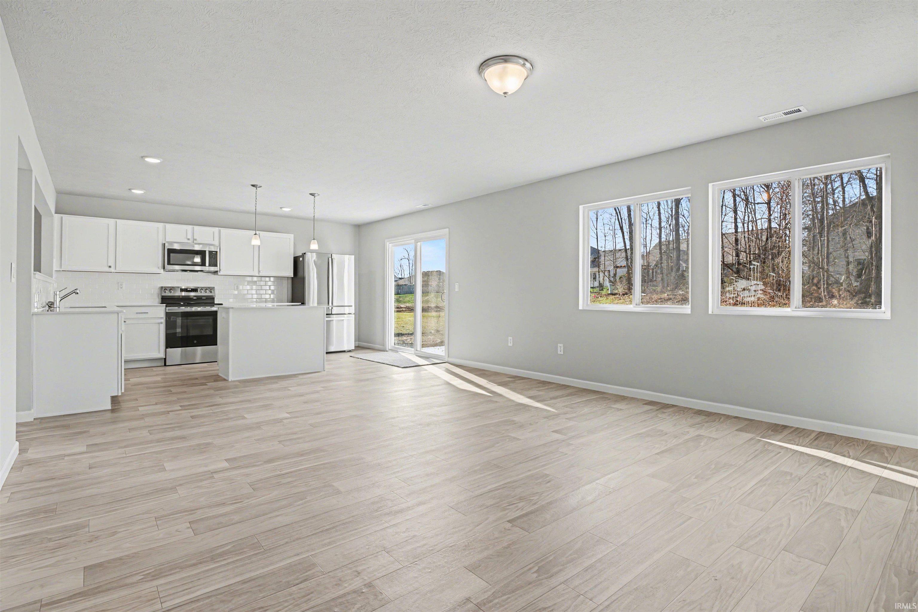 The kitchen offers open sight lines into the great room and consistent flooring allows for a smooth transition.