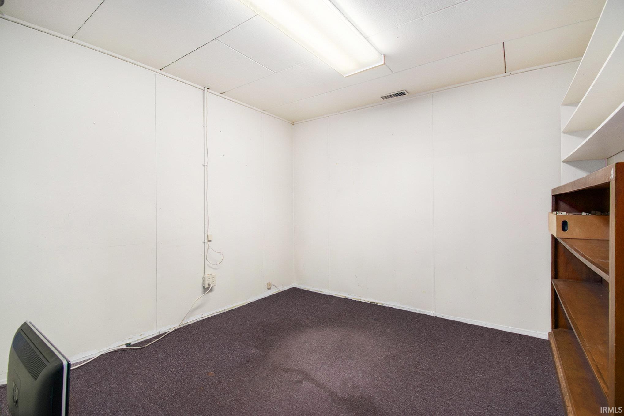 Carpeted empty room with heating unit