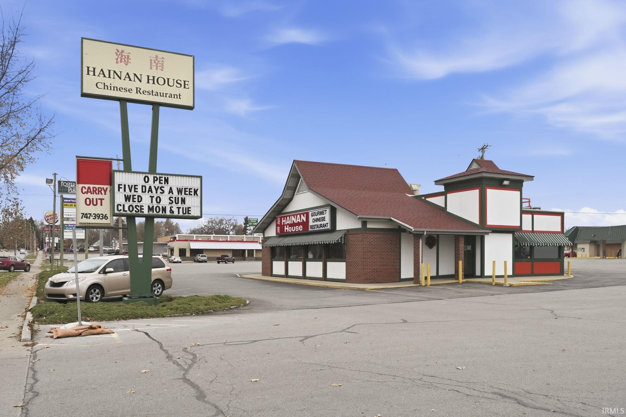 View of commercial location featuring uncovered parking