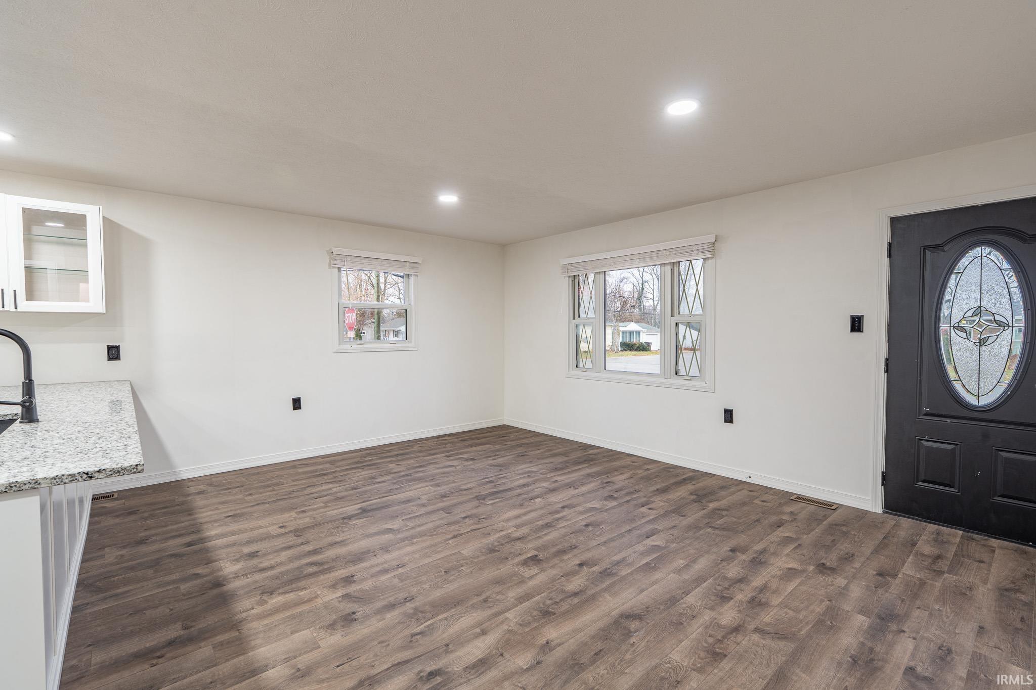 Entrance foyer featuring dark wood finished floors and recessed lighting