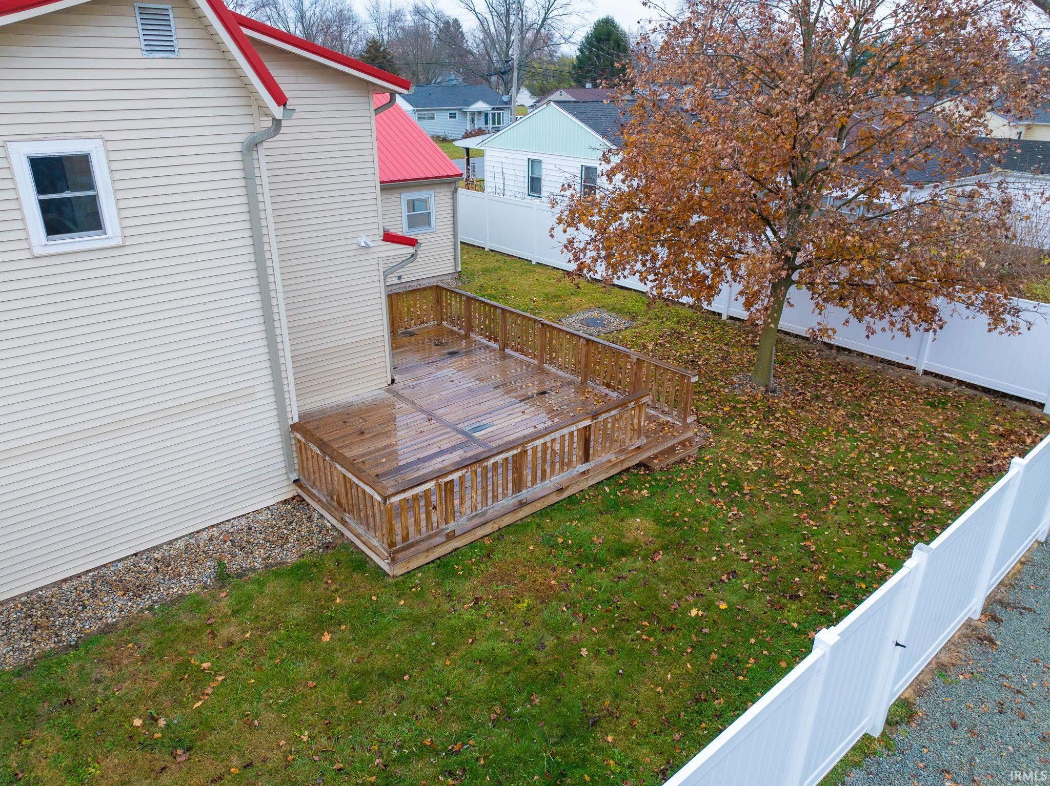Fenced backyard with a wooden deck and a residential view