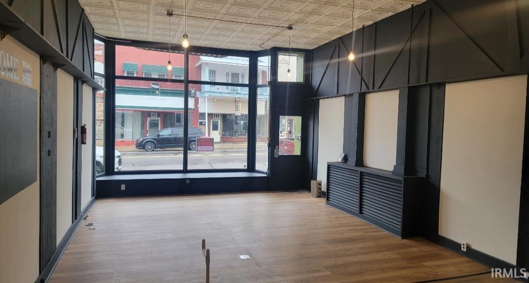 Spare room with an ornate ceiling and light wood-type flooring