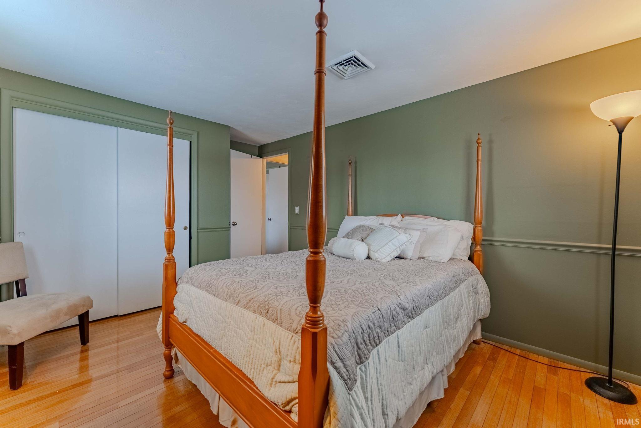 Bedroom with a closet and wood-type flooring