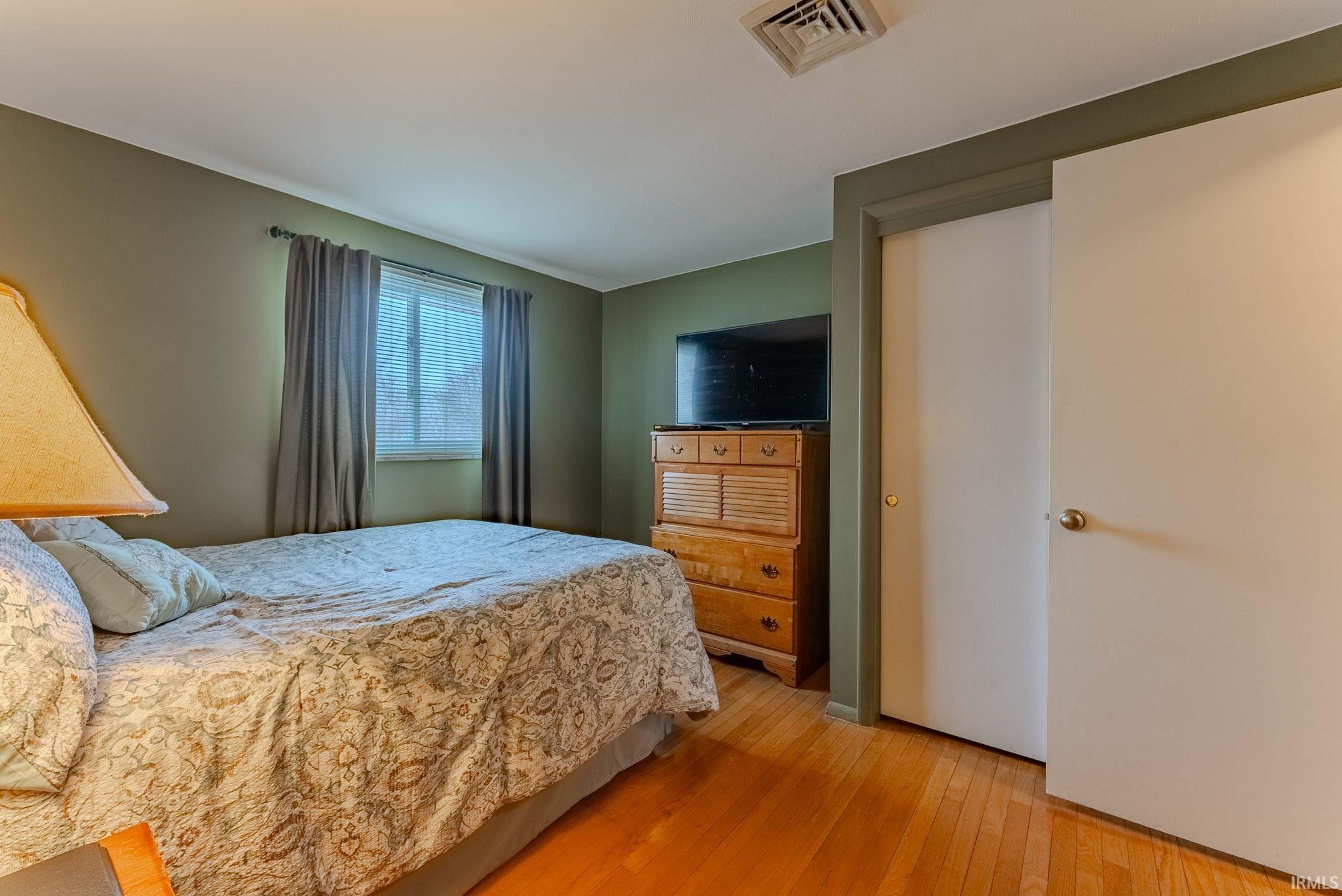 Bedroom with hardwood / wood-style floors