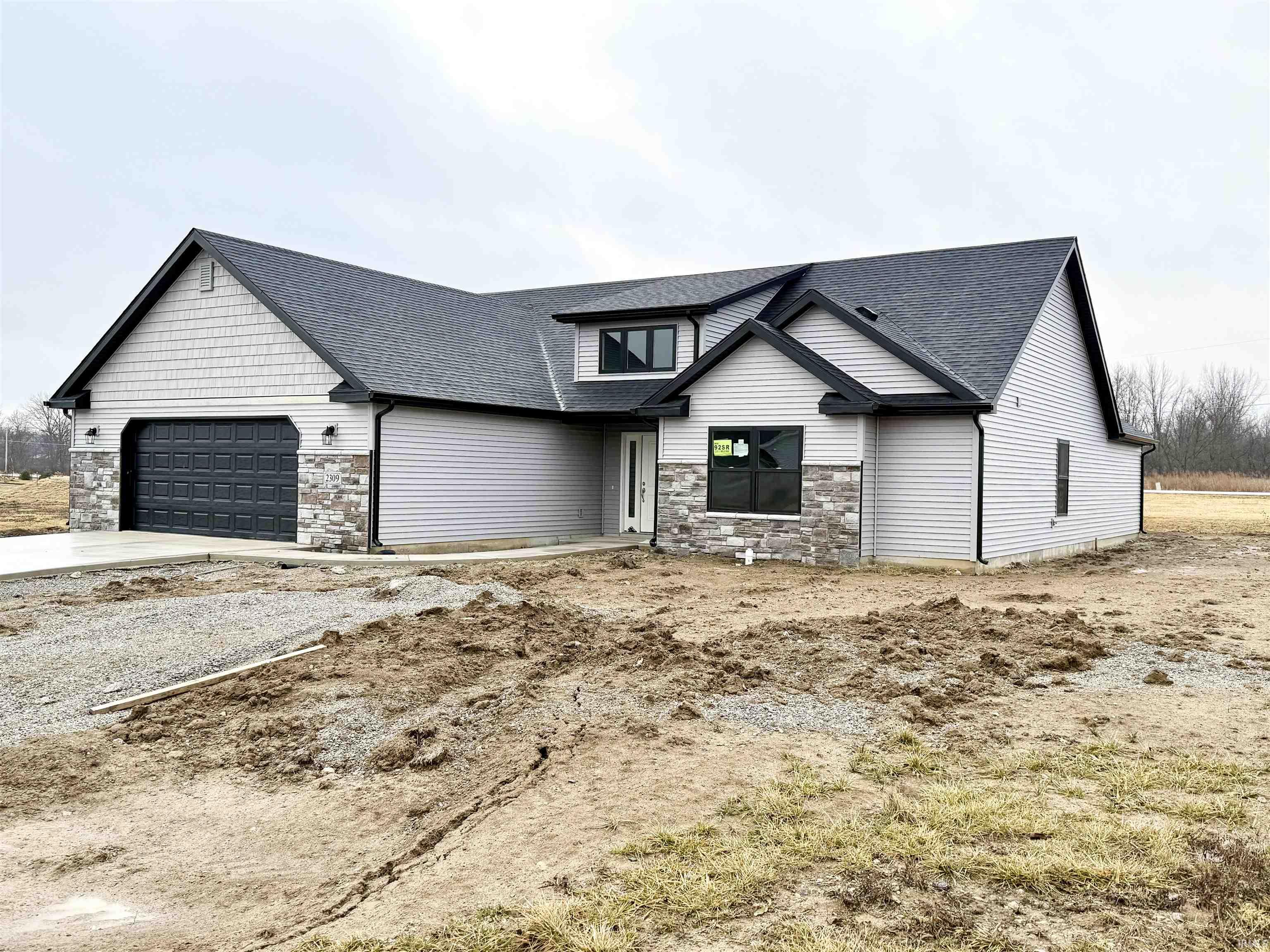View of front of home with stone siding, roof with shingles, driveway, and a garage