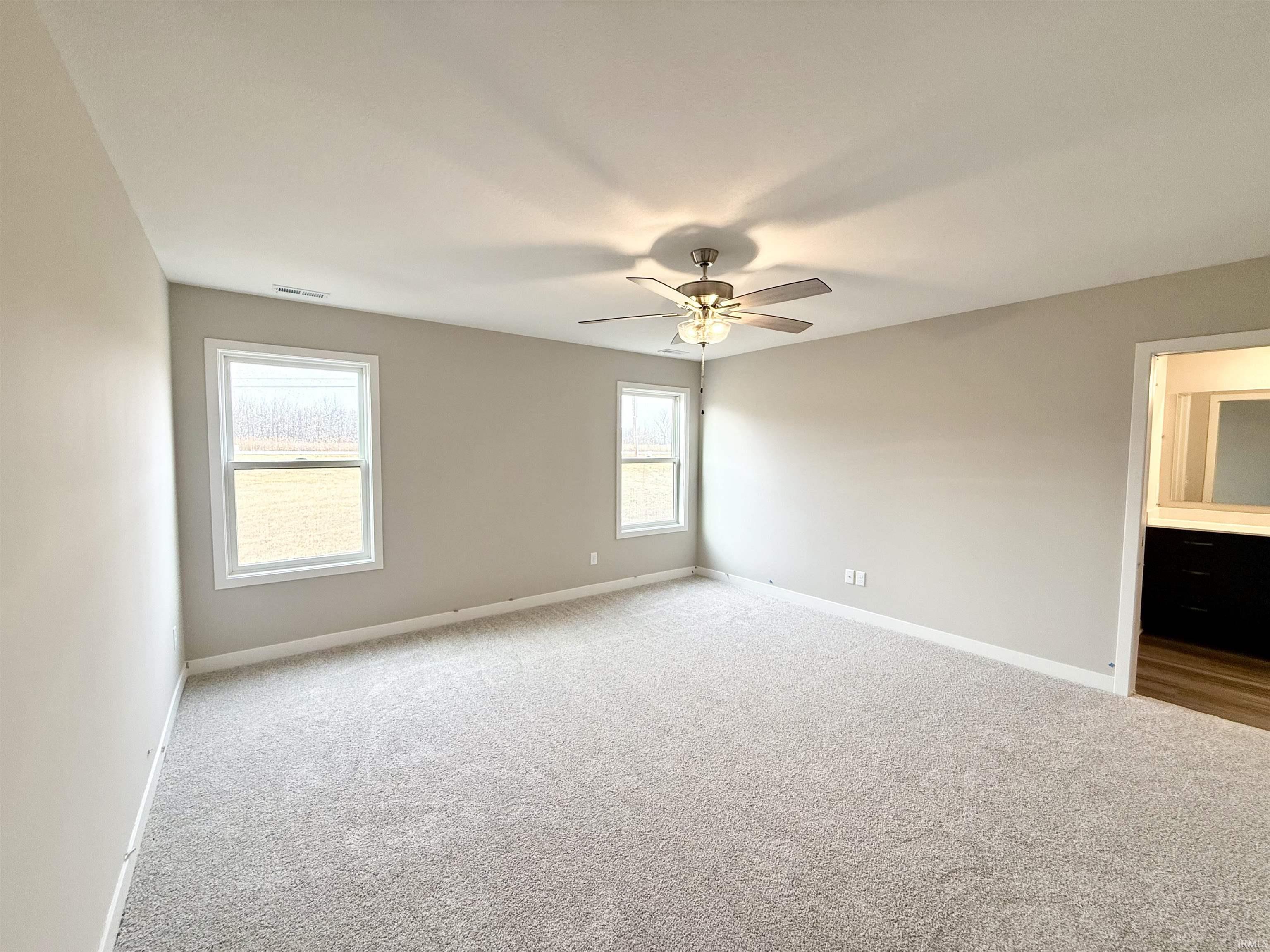 Unfurnished room featuring carpet floors and ceiling fan