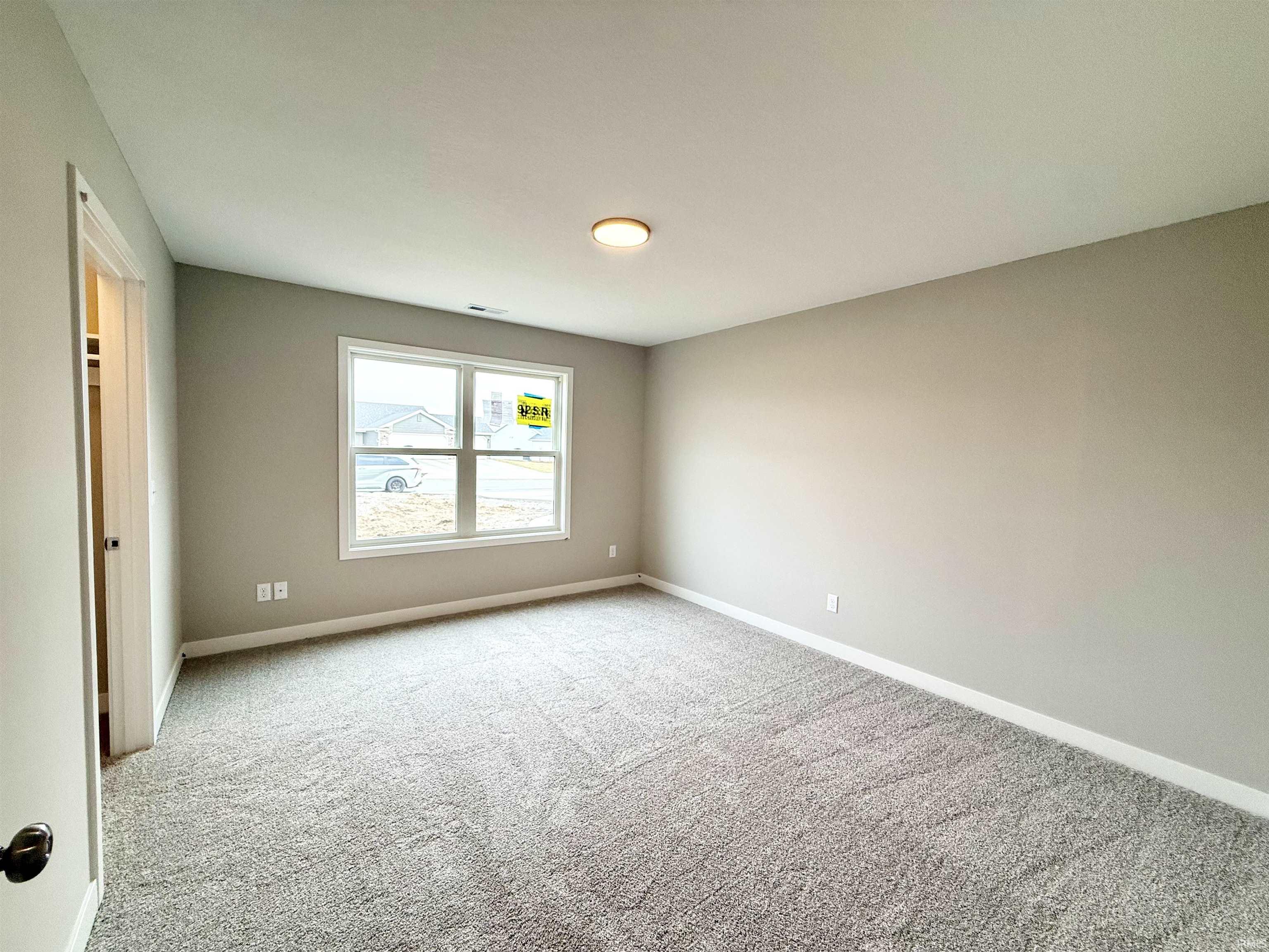 Unfurnished room with baseboards and carpet
