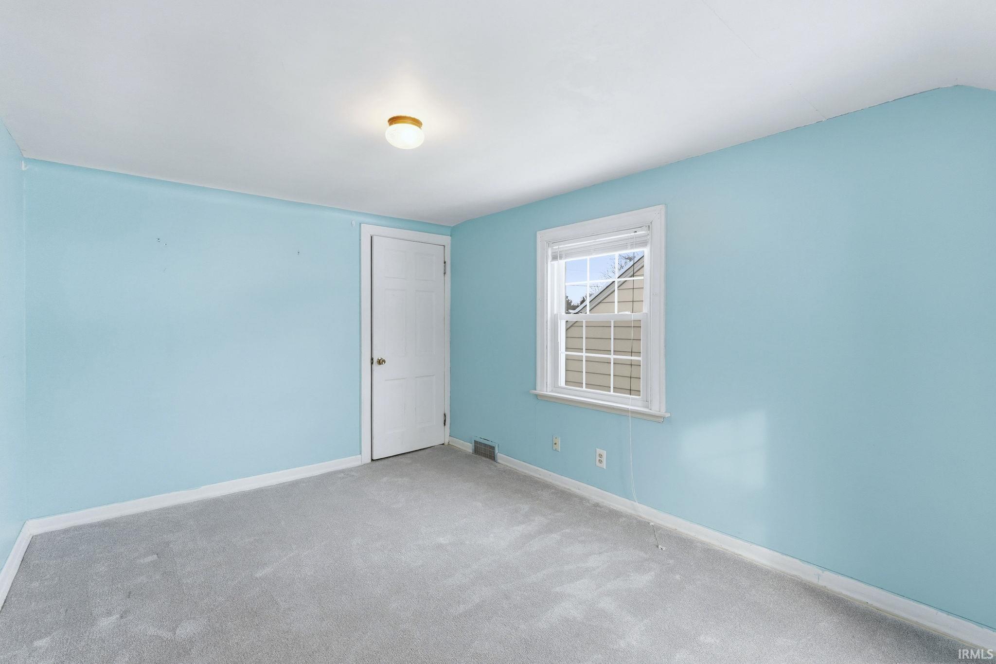 Spare room with carpet flooring and baseboards