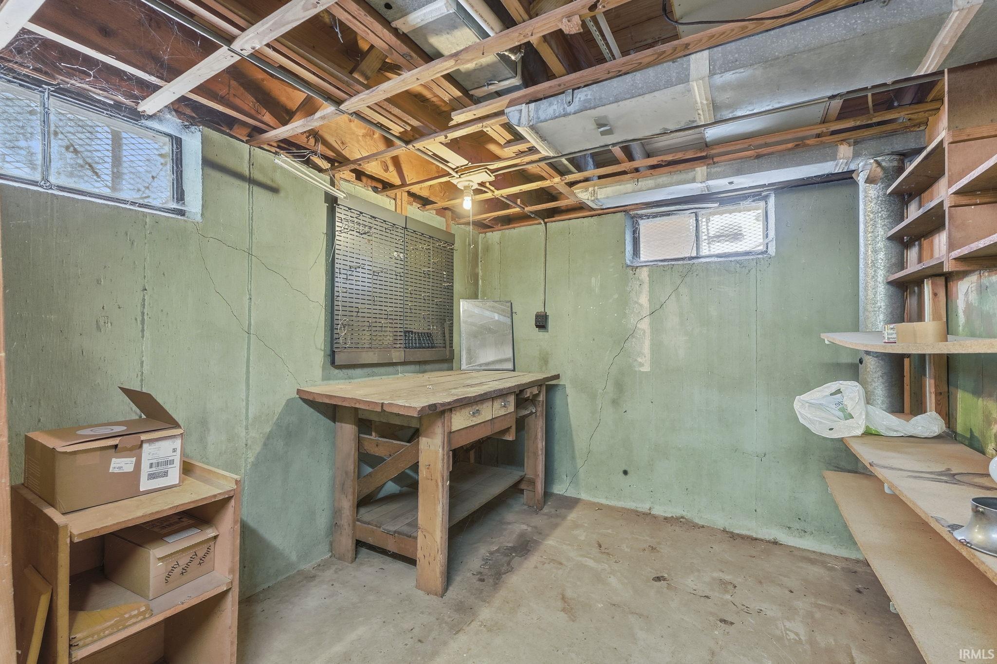 Basement with plenty of natural light and a workshop area