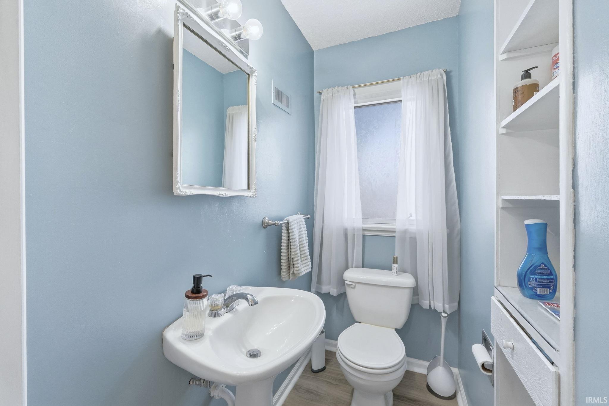 Bathroom featuring toilet and wood finished floors