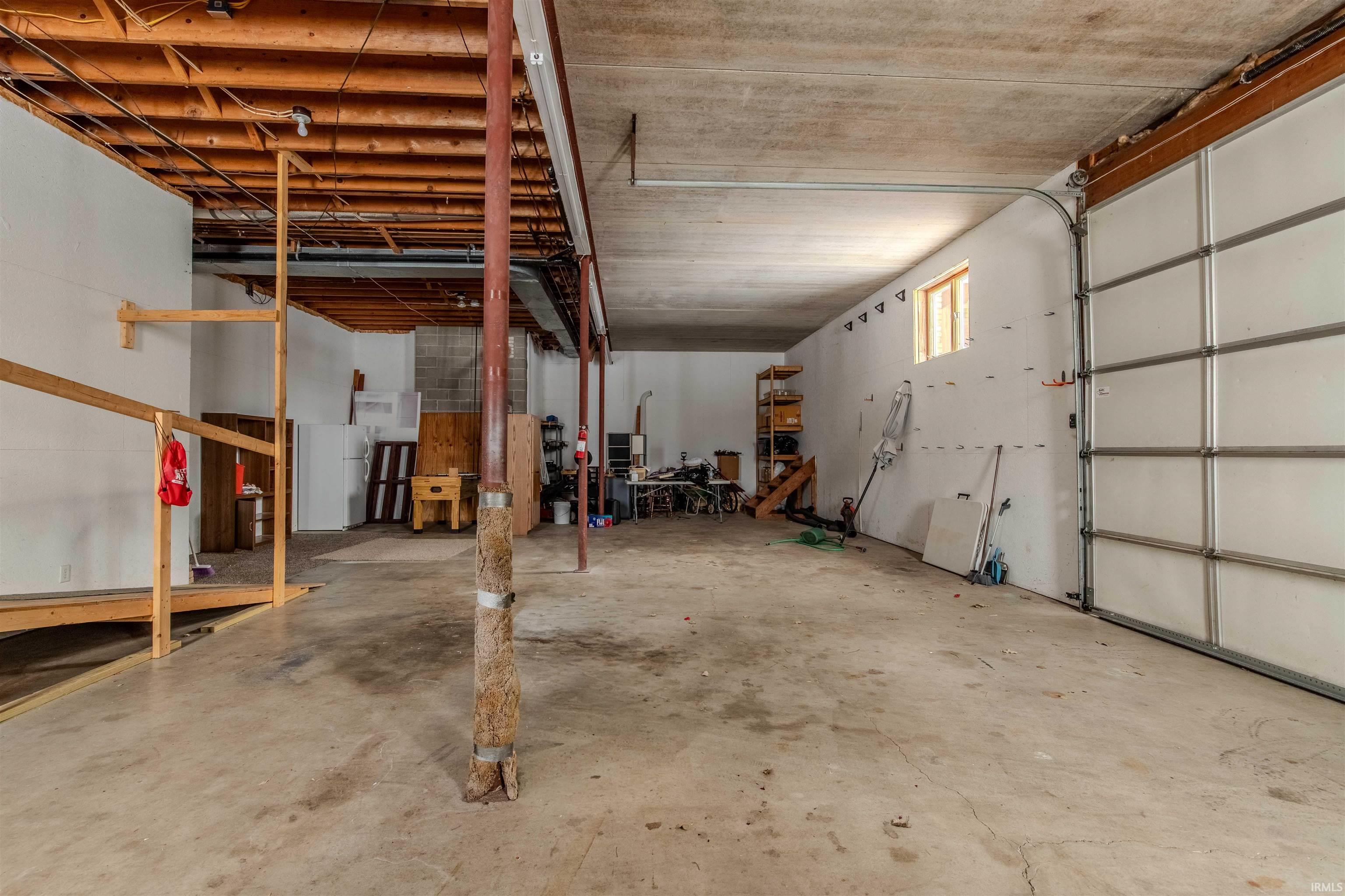 Garage featuring freestanding refrigerator
