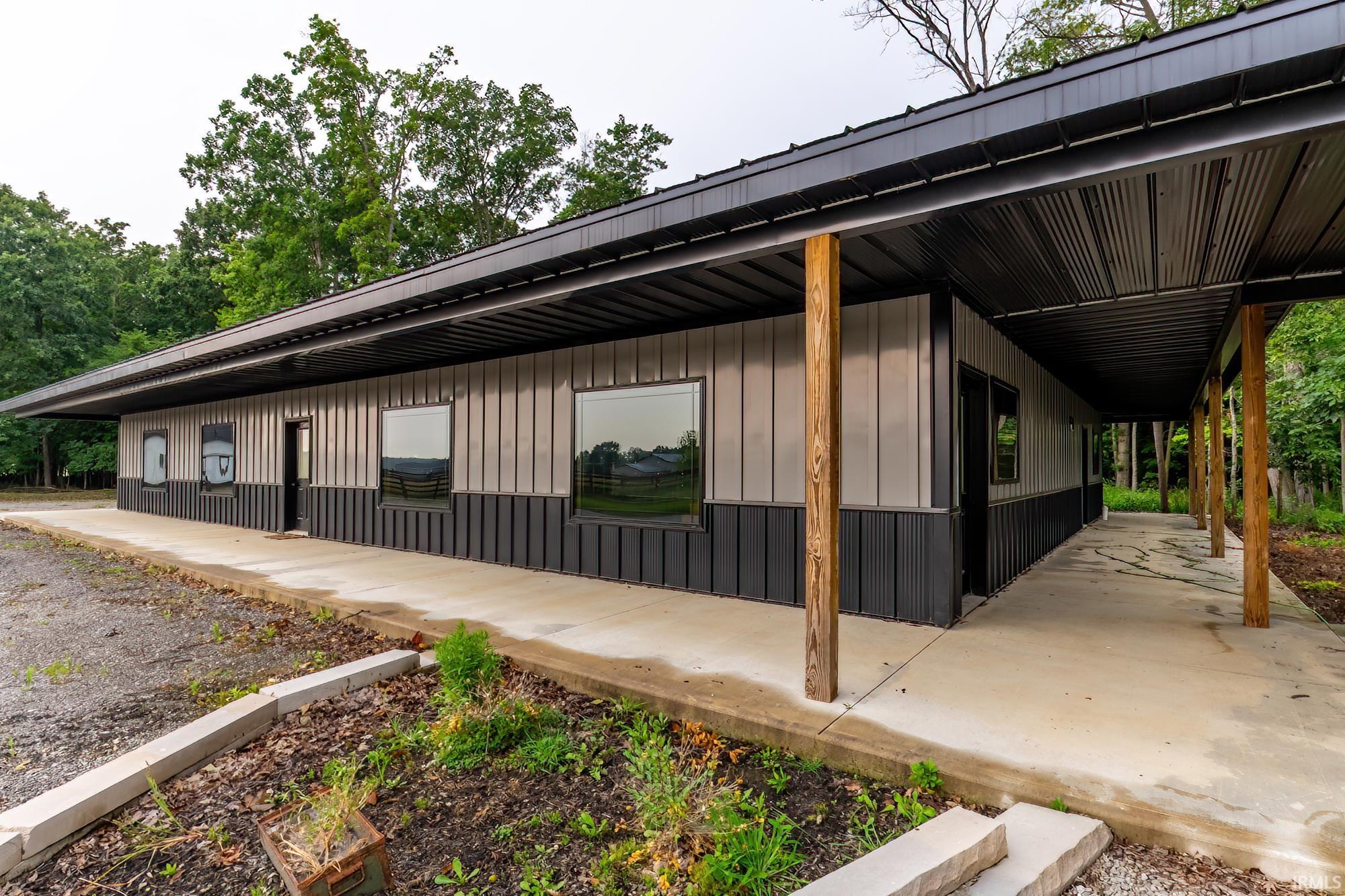 Corrugated metal exterior featuring a dark grey lower panel and lighter grey upper panel