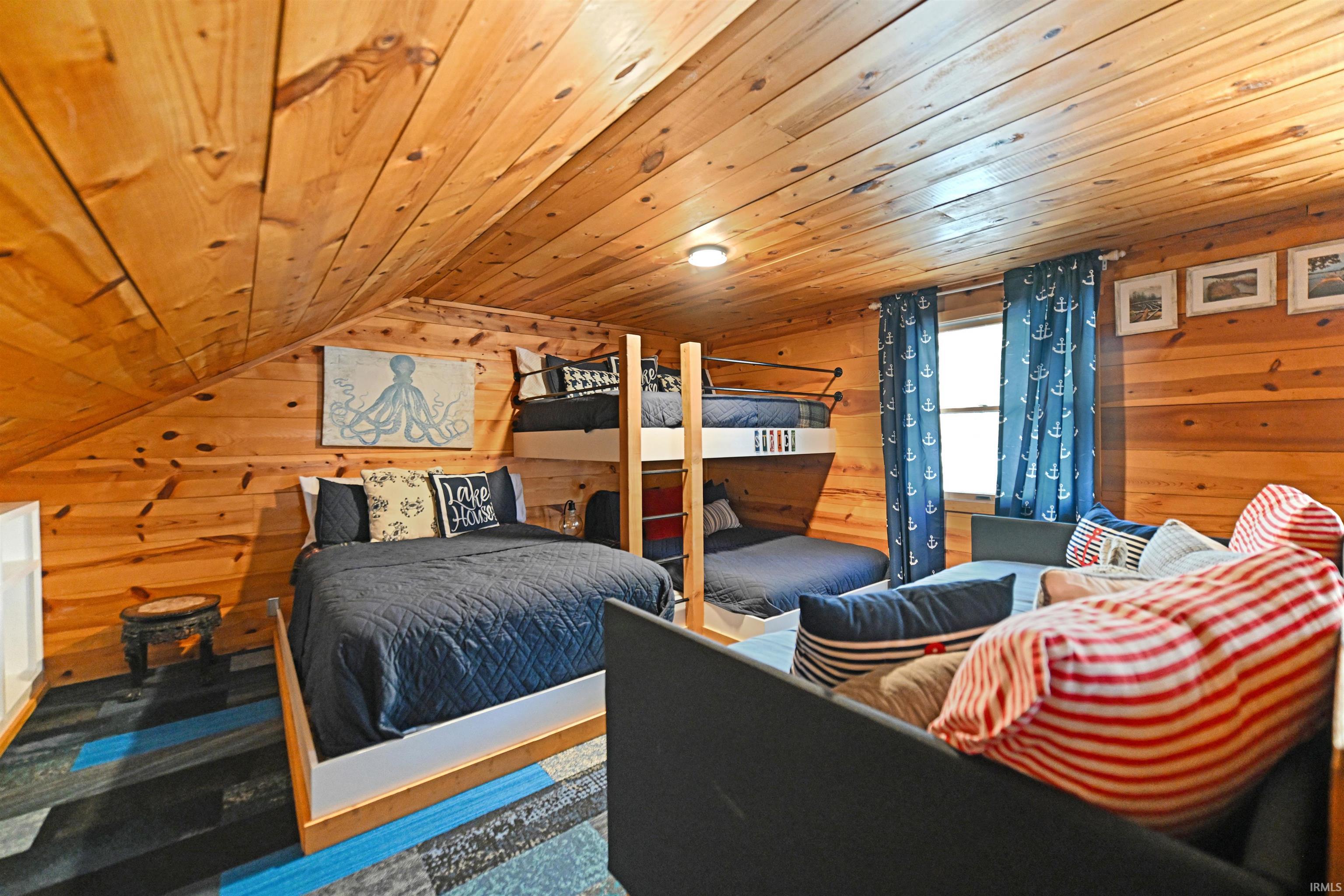 Bedroom with wooden ceiling and wooden walls