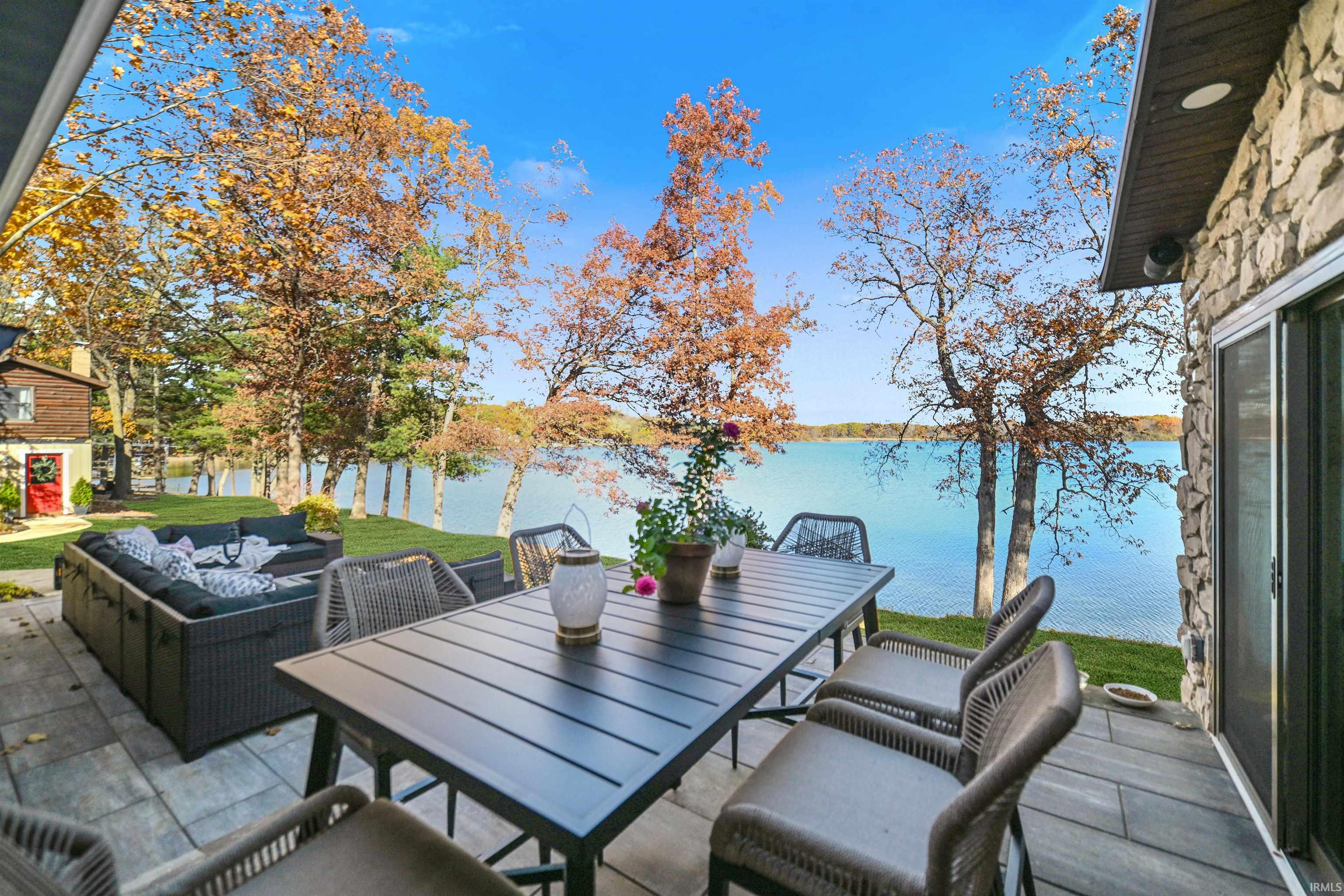 View of patio with an outdoor living space, a water view, and outdoor dining space