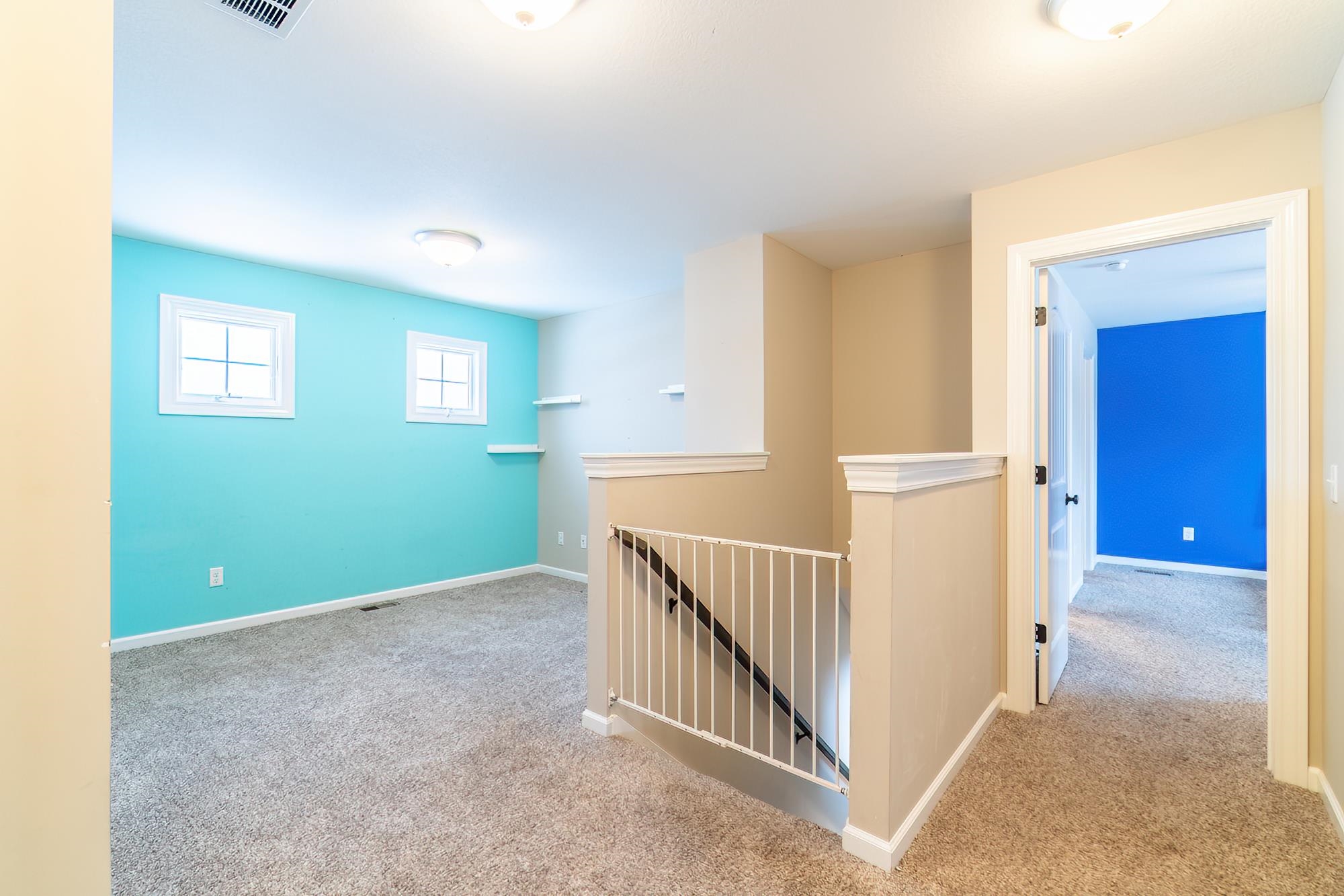 Corridor featuring an upstairs landing and carpet floors