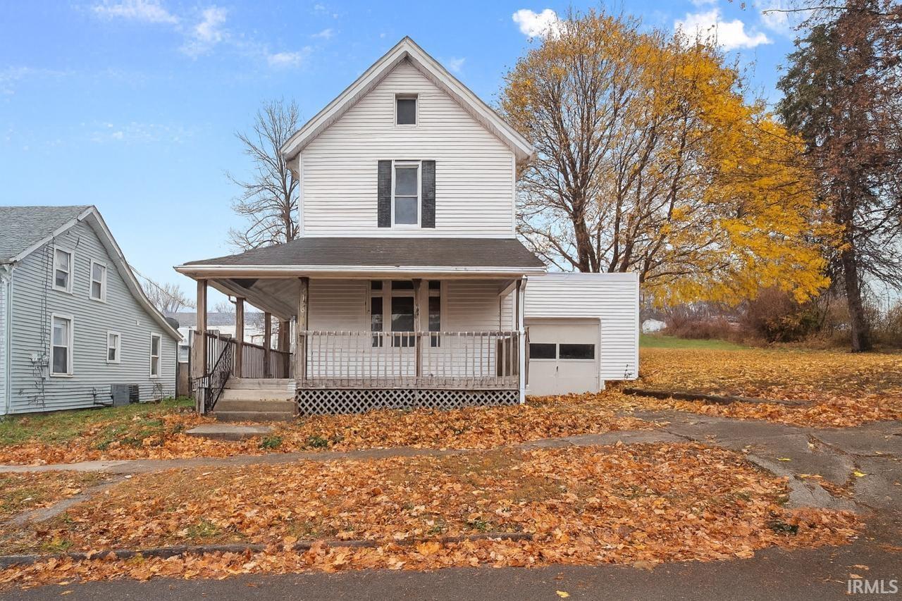 View of front facade with a porch and a garage