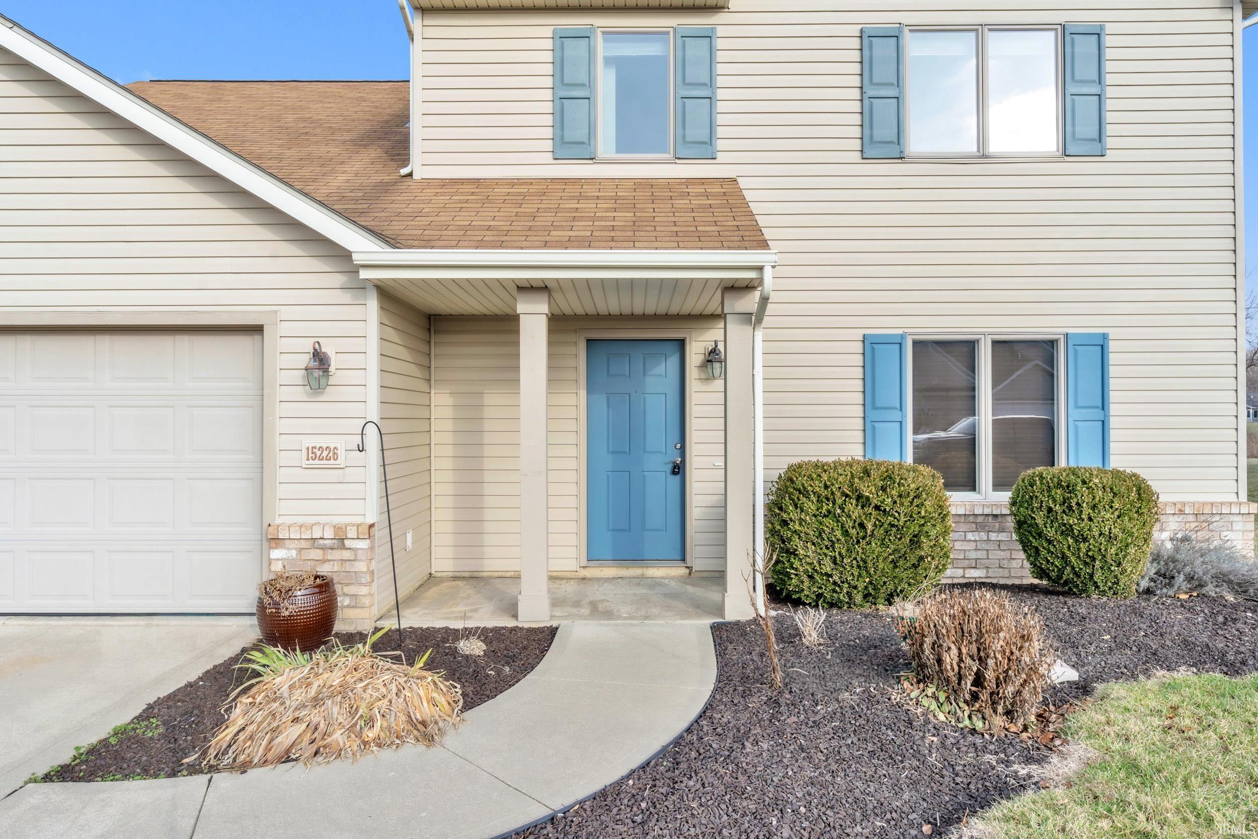 View of exterior entry featuring roof with shingles and a garage