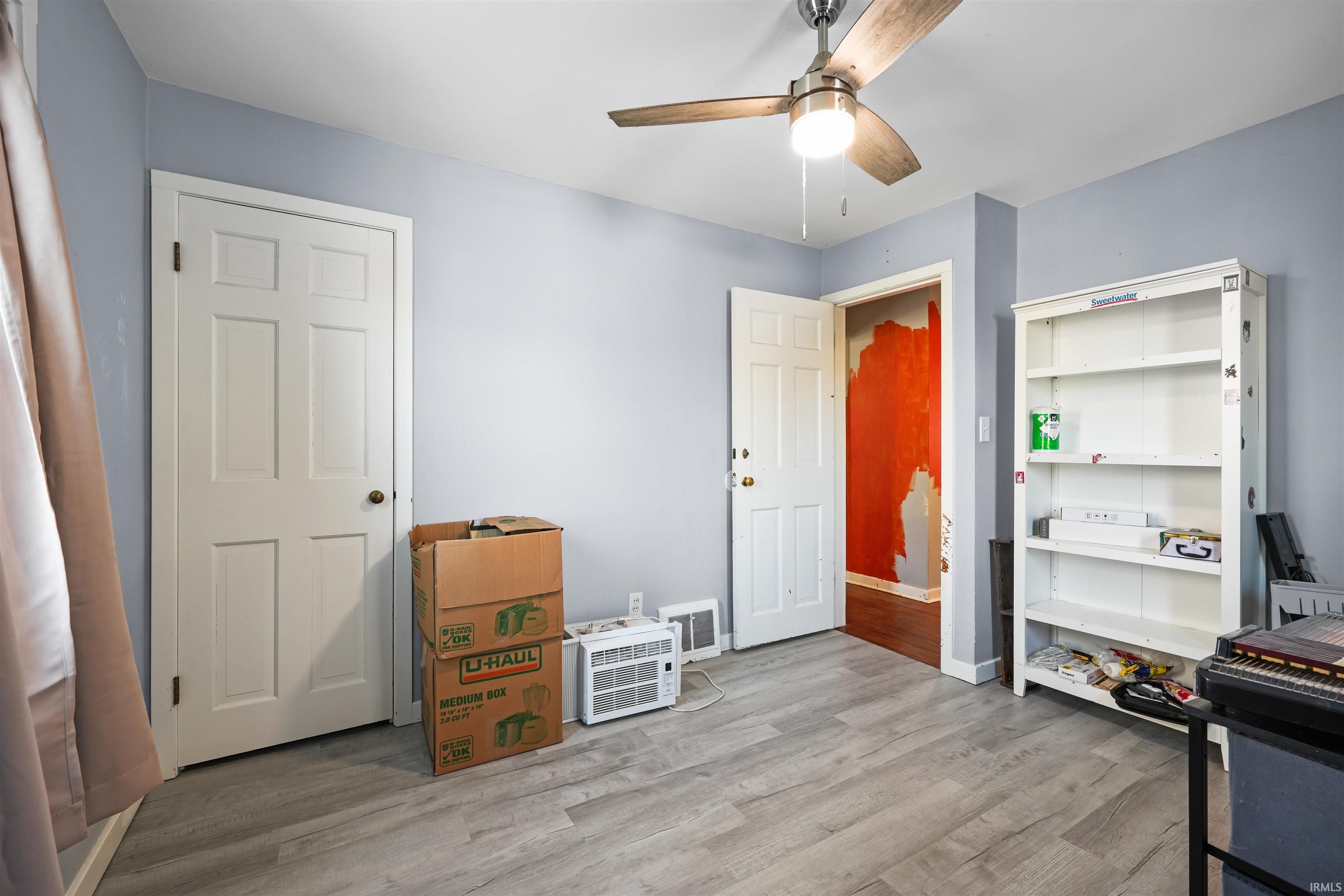 Bedroom featuring a ceiling fan and light flooring