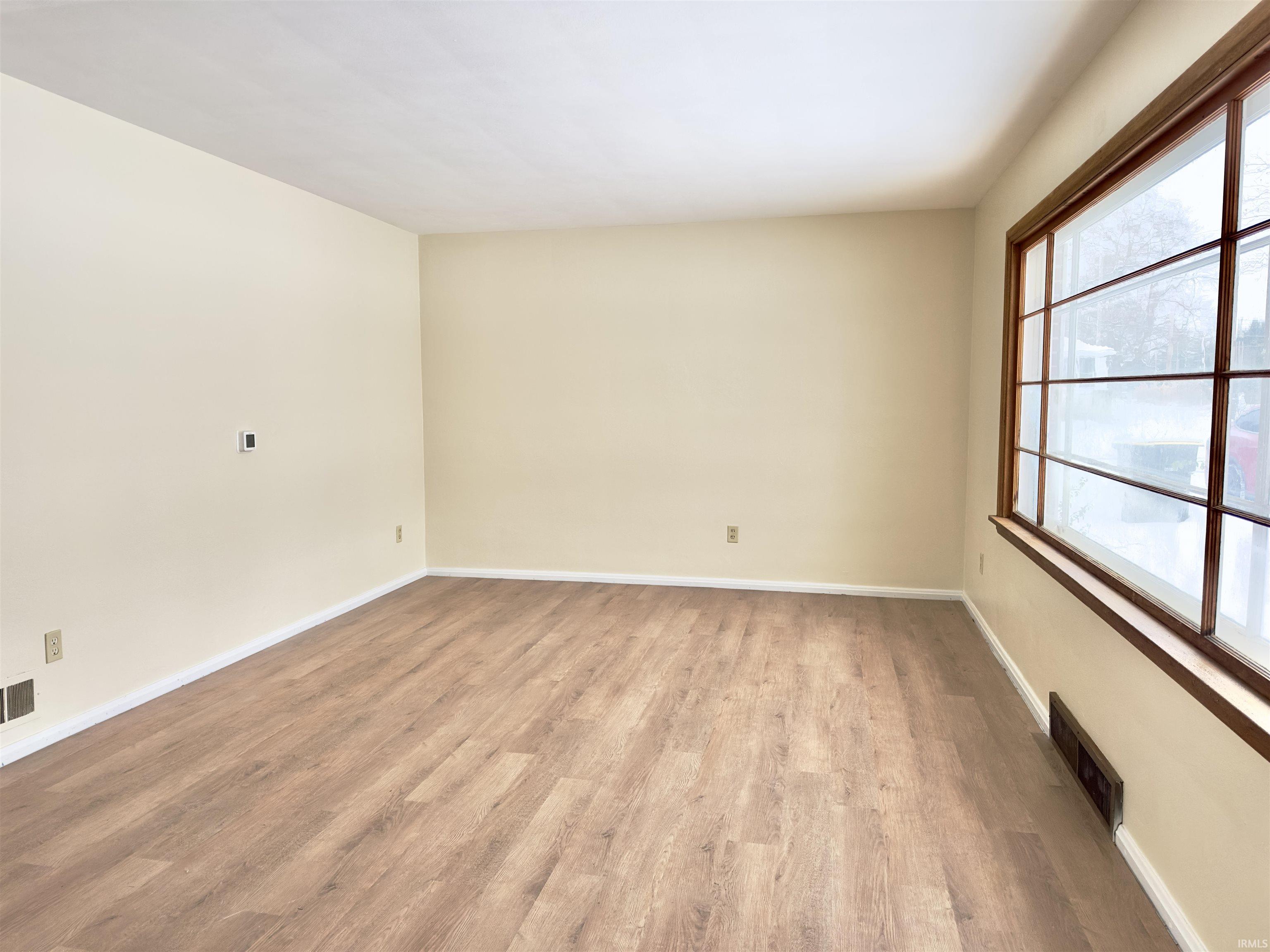Spare room with light wood finished floors and baseboards