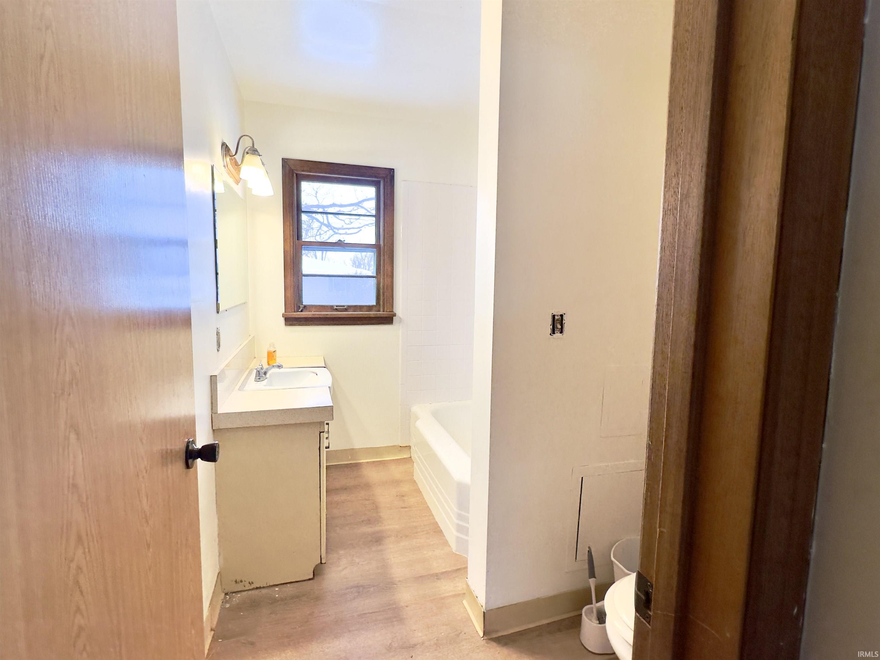 Full bathroom featuring vanity and light wood finished floors