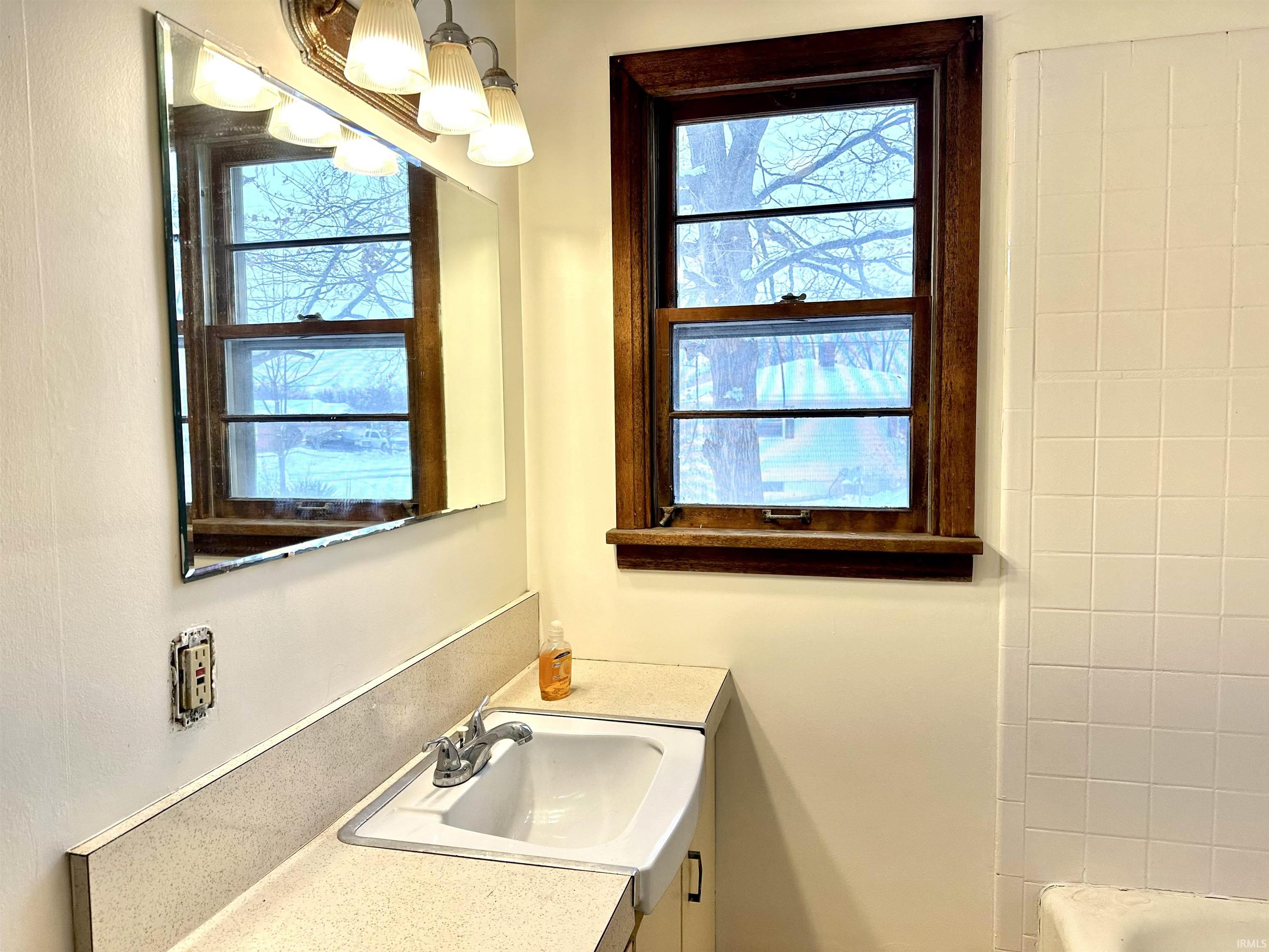 Bathroom featuring vanity and plenty of natural light