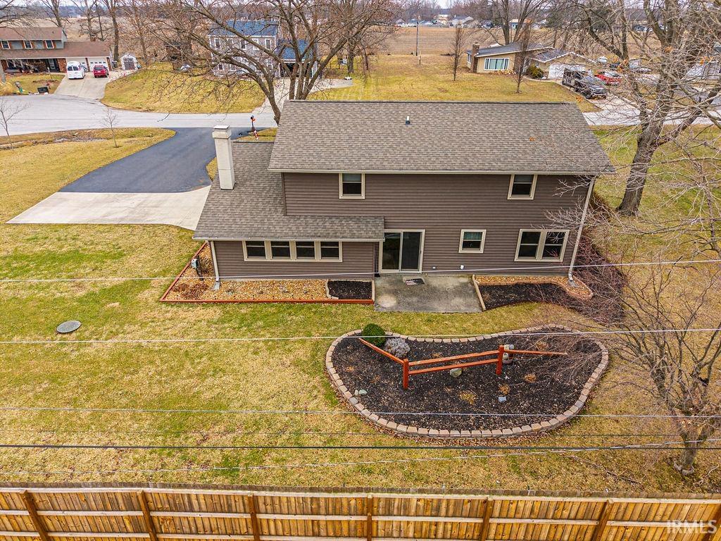 Back of property with a chimney, a patio area, and a residential view