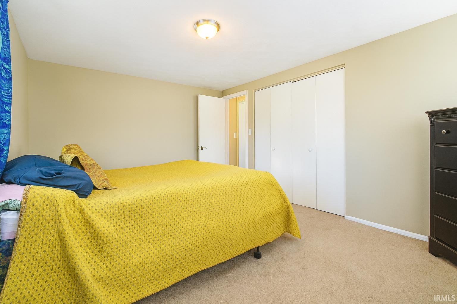 Bedroom featuring carpet floors and a closet