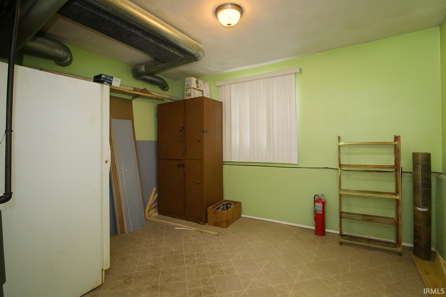 Unfurnished bedroom with light floors and baseboards