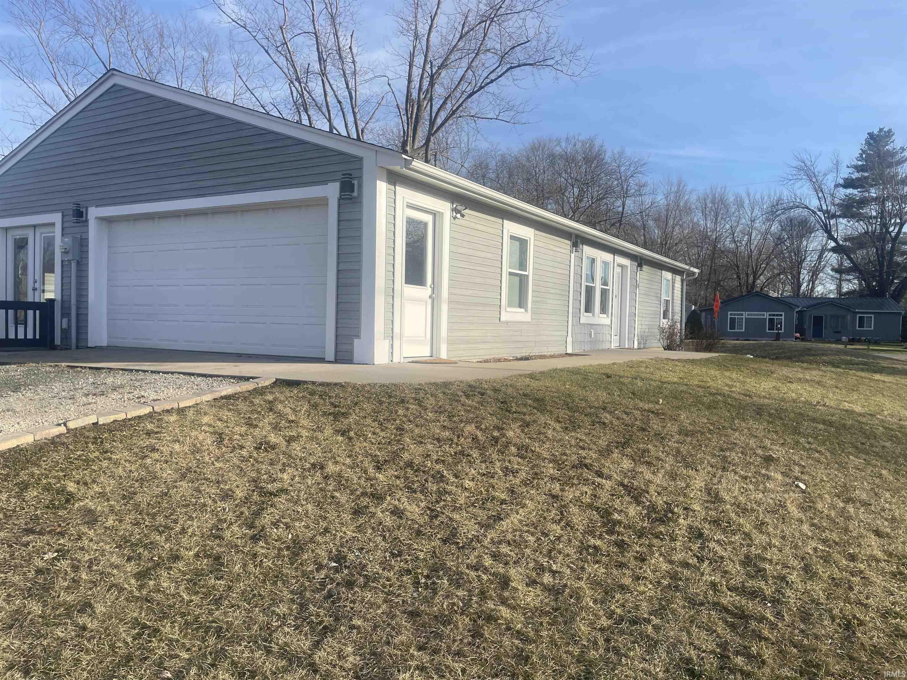 View of front facade with a garage and a front yard