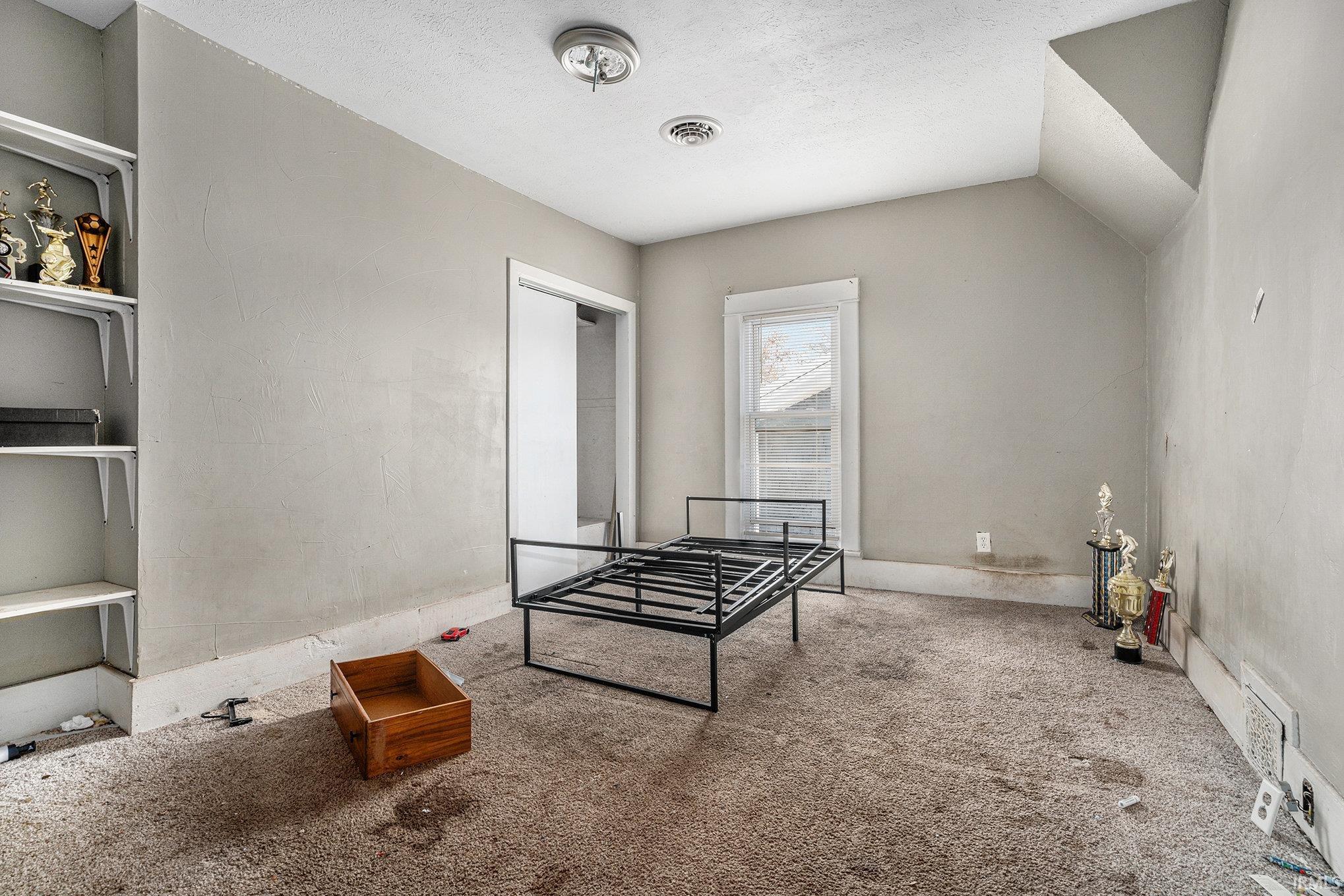Game room with carpet flooring and a textured ceiling