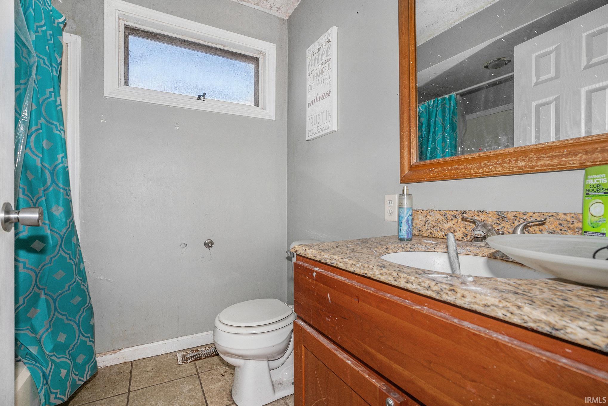 Full bathroom with vanity and light tile patterned floors