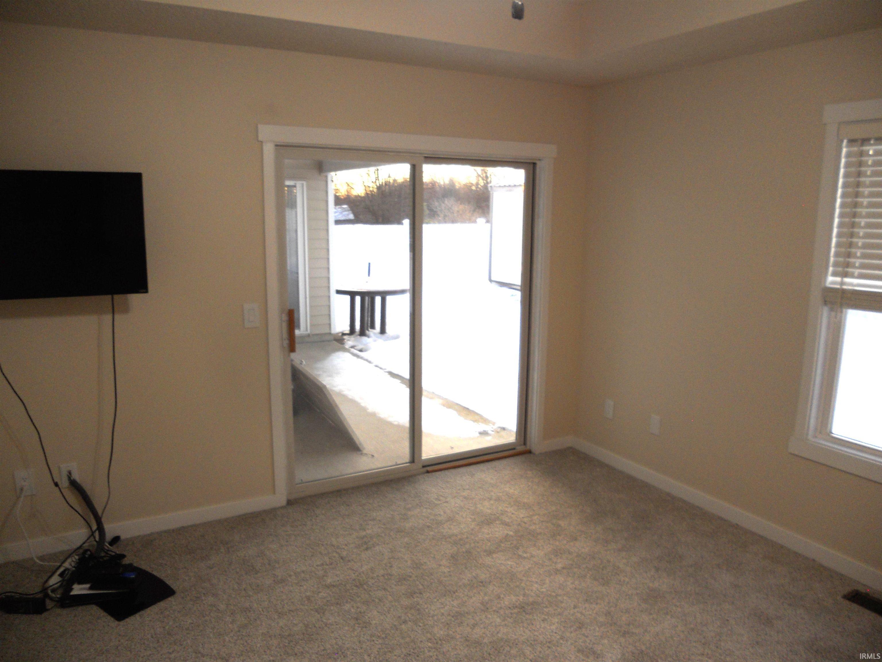 Unfurnished room featuring healthy amount of natural light and carpet floors