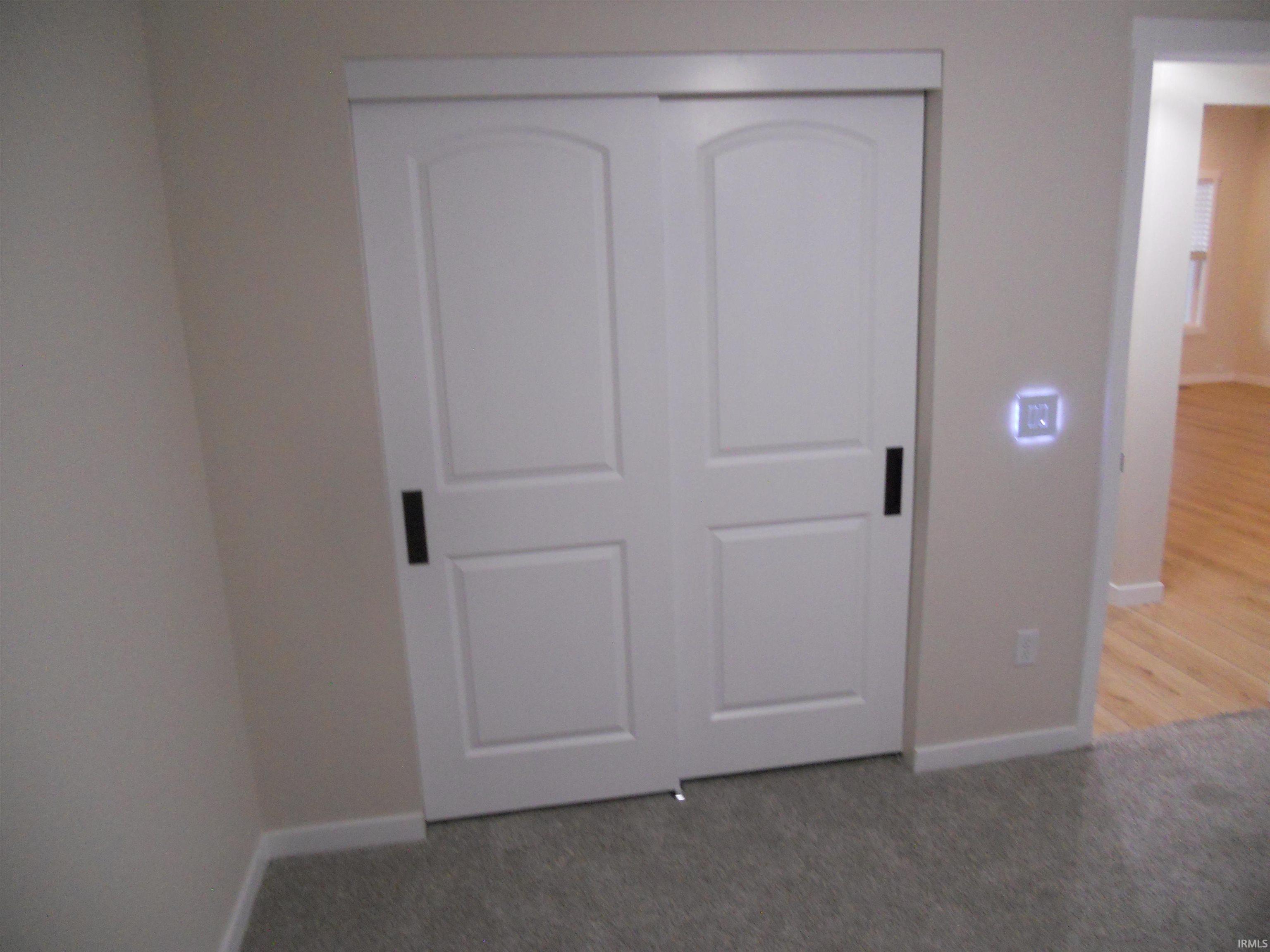 Unfurnished bedroom with a closet and light carpet