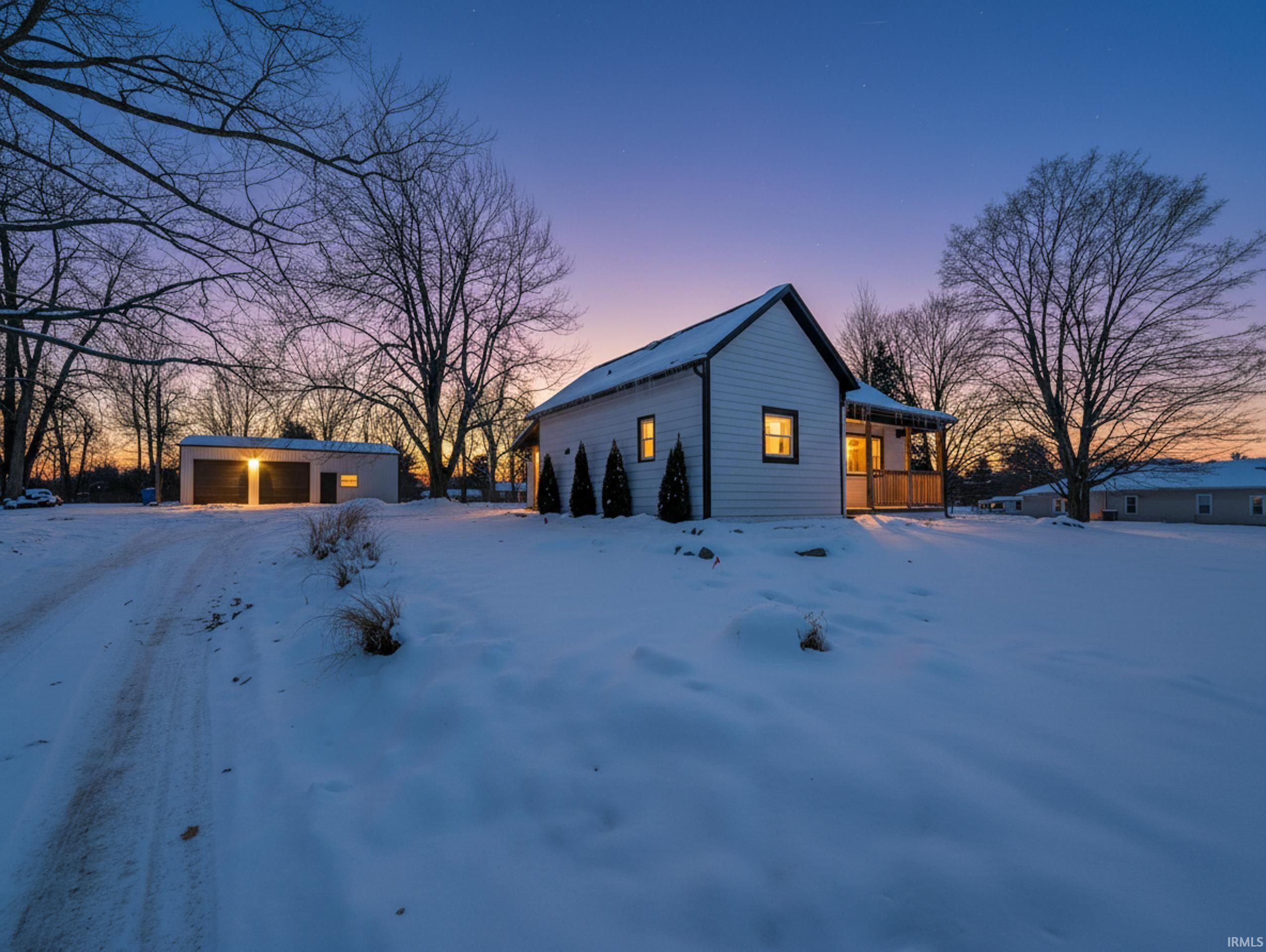 View of snow covered exterior featuring an outdoor structure