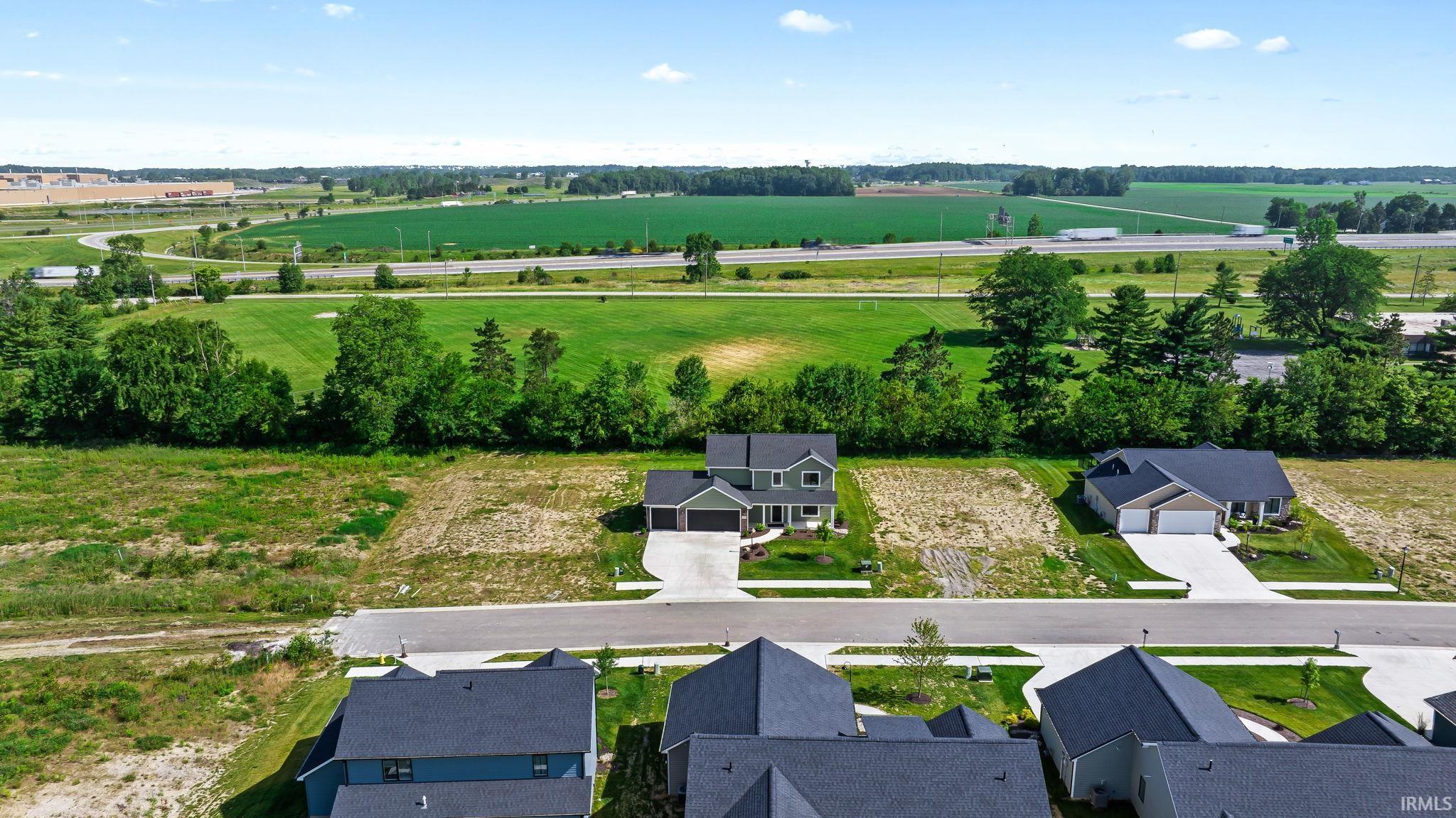 Newly constructed two-story residence featuring a two-car garage, concrete driveway, and manicured front lawn