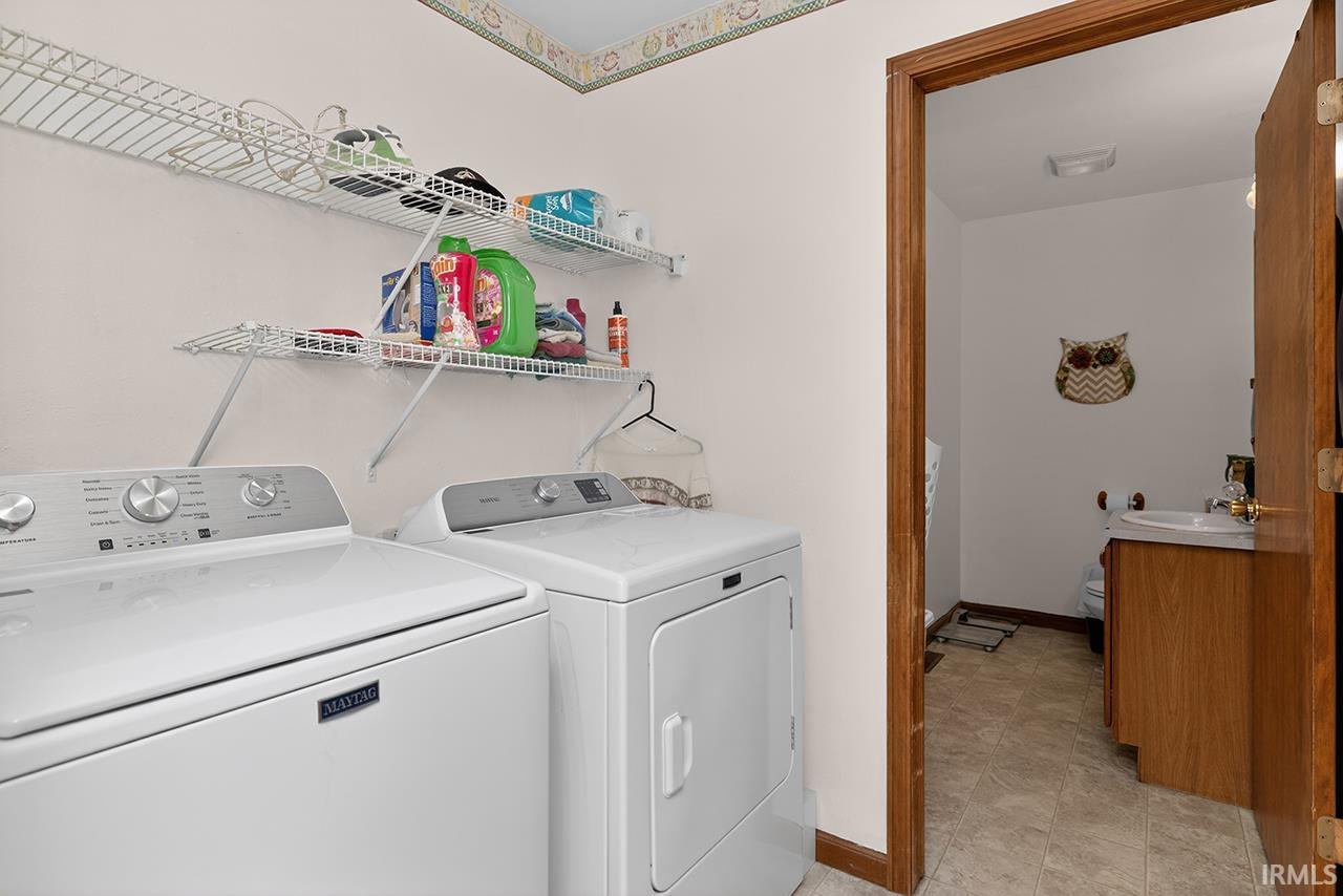 Laundry room with washing machine and dryer and baseboards