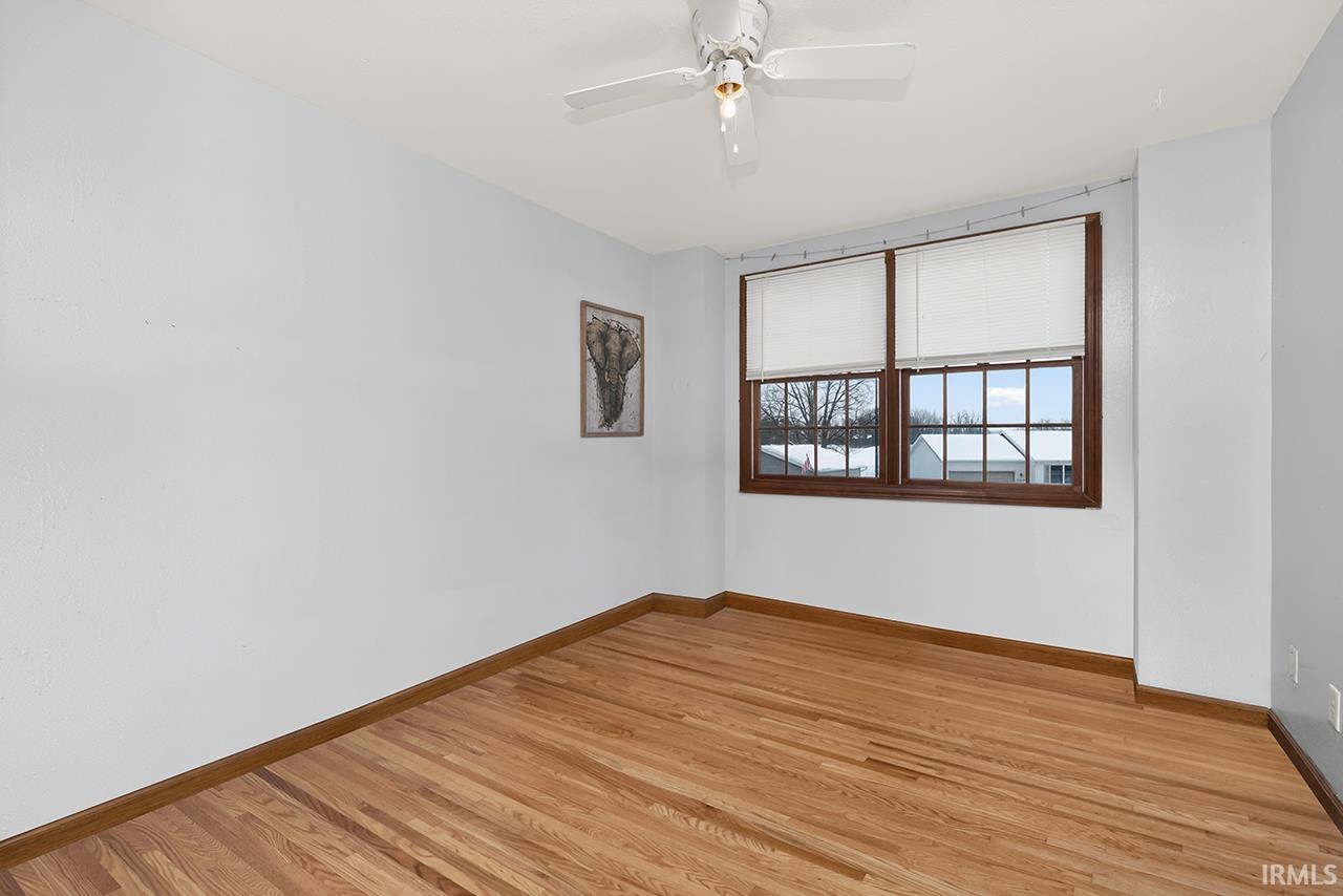 Unfurnished room with light wood finished floors and a ceiling fan