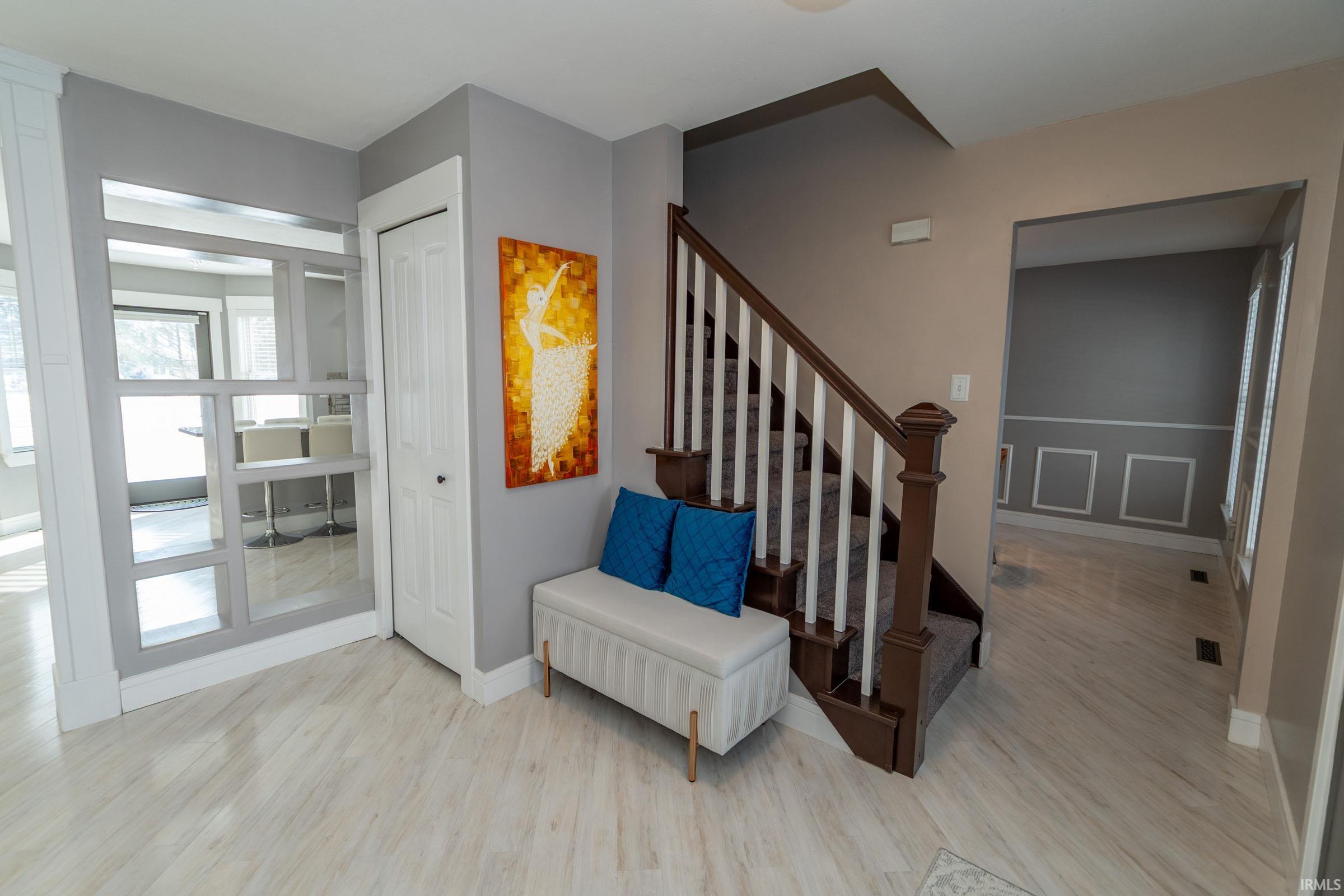 Stairs with wood finished floors and baseboards