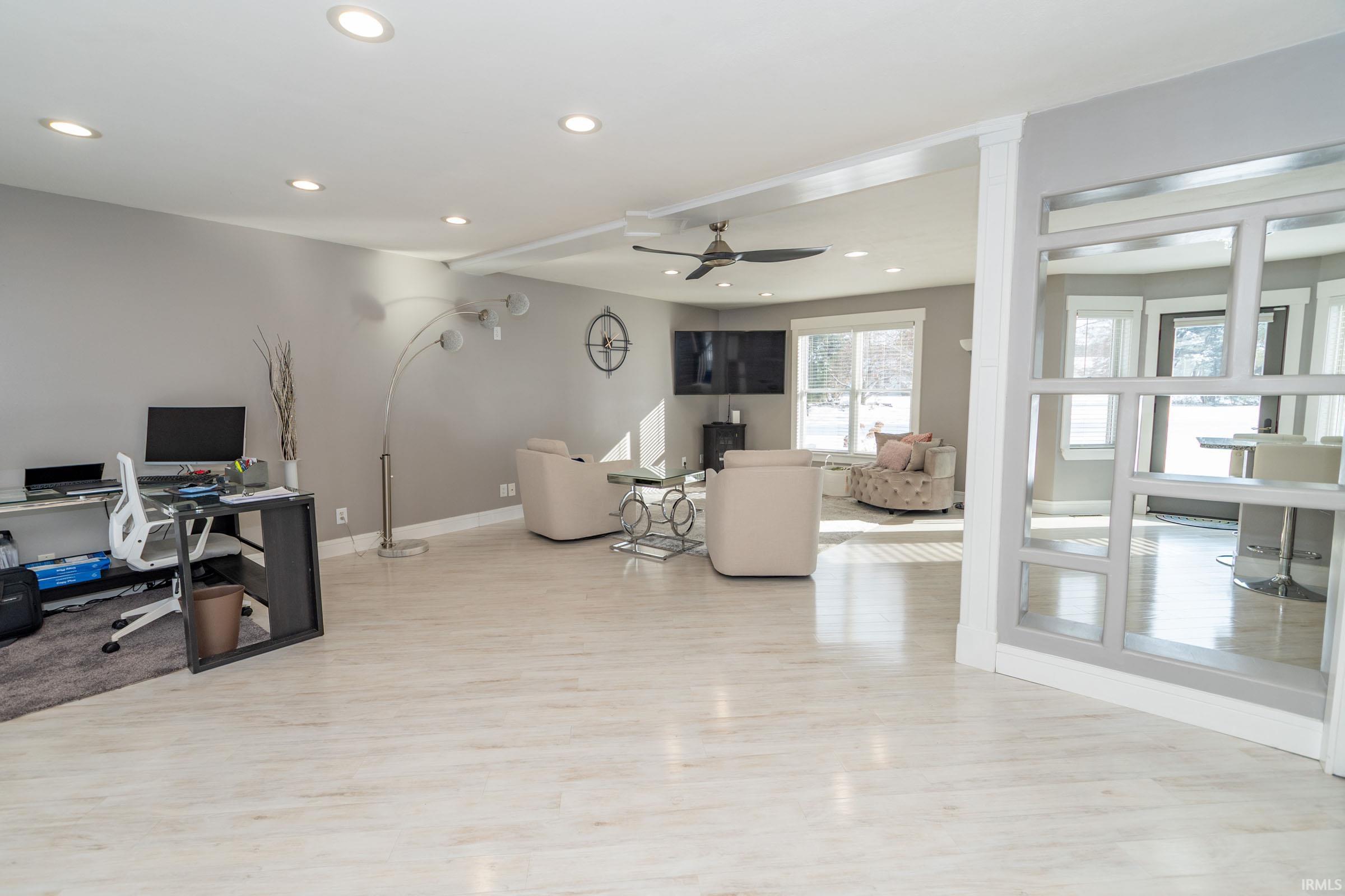 Living room featuring an office area, recessed lighting, a ceiling fan, and light wood finished floors
