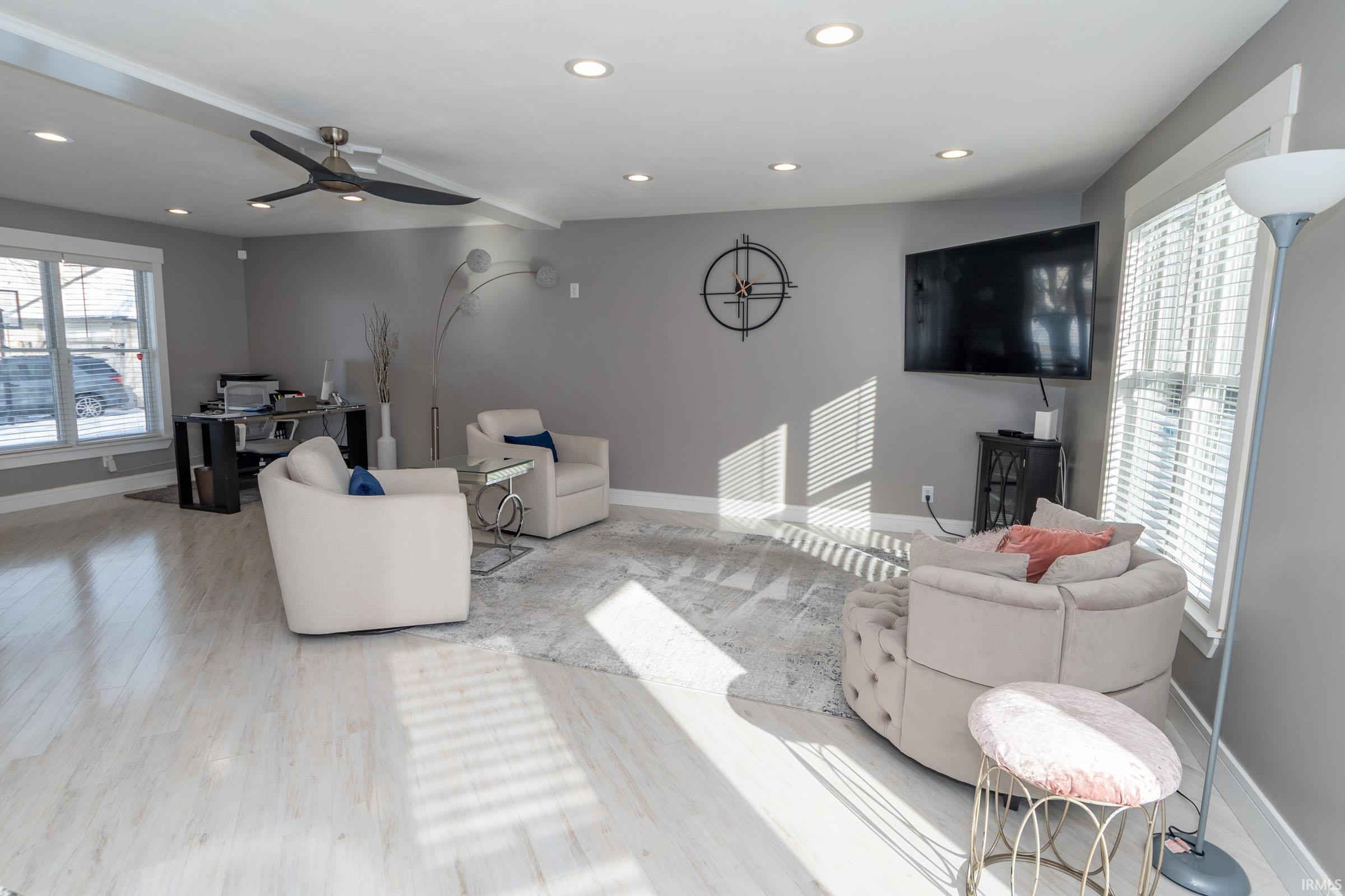 Living area with recessed lighting, ceiling fan, and wood finished floors