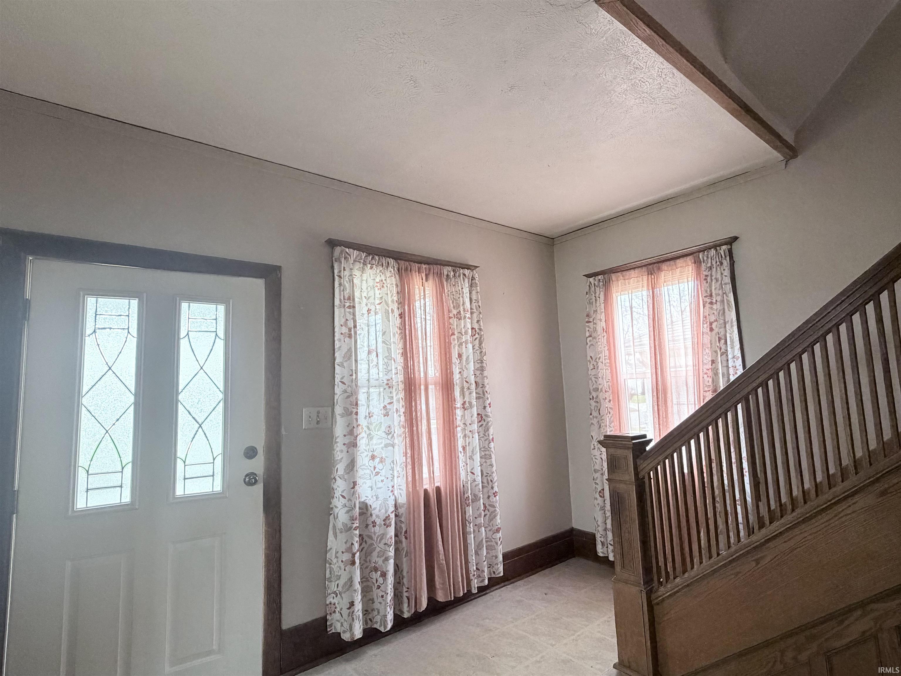 Foyer featuring a textured ceiling and light tile patterned floors