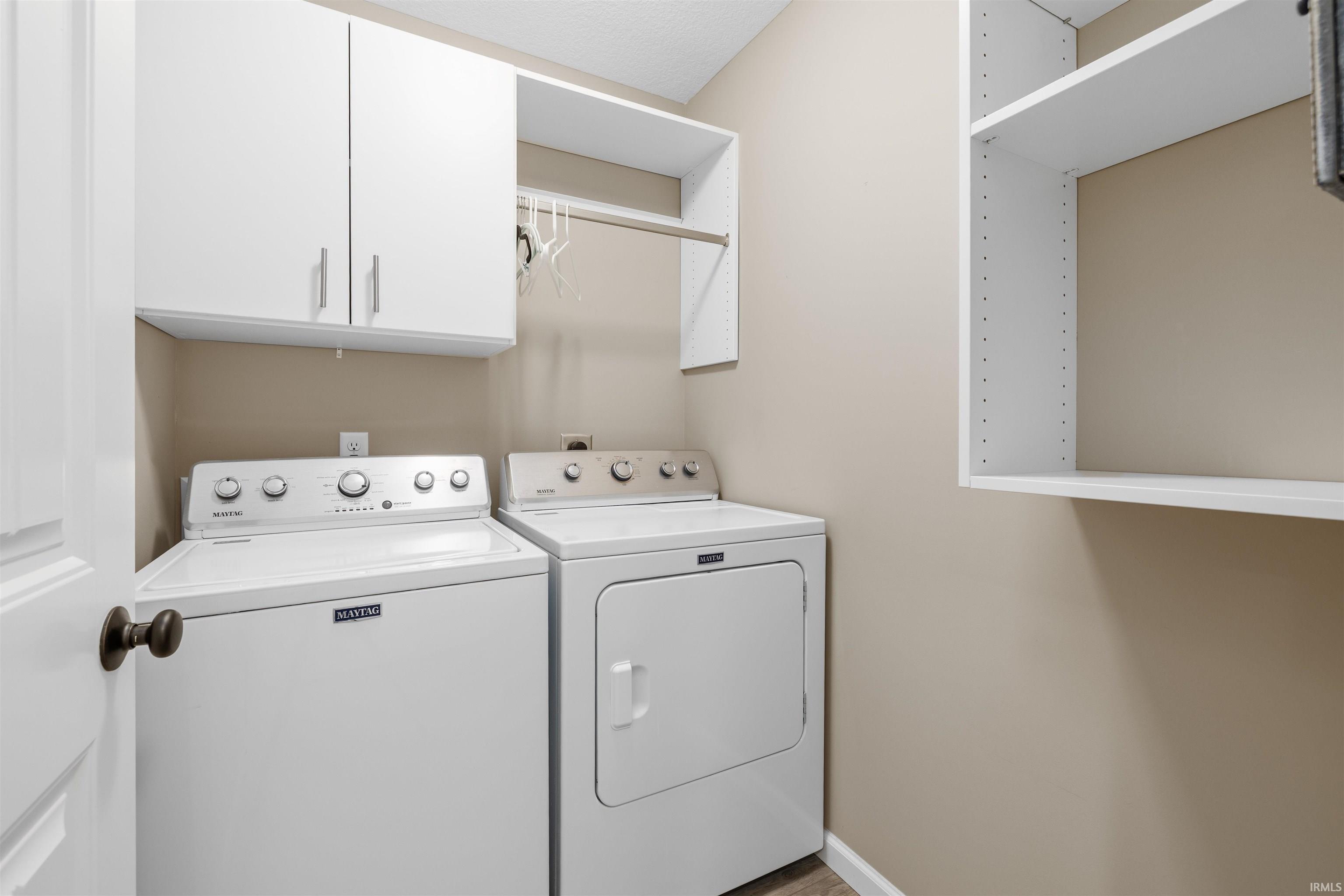 Laundry area featuring cabinet space and washer and dryer
