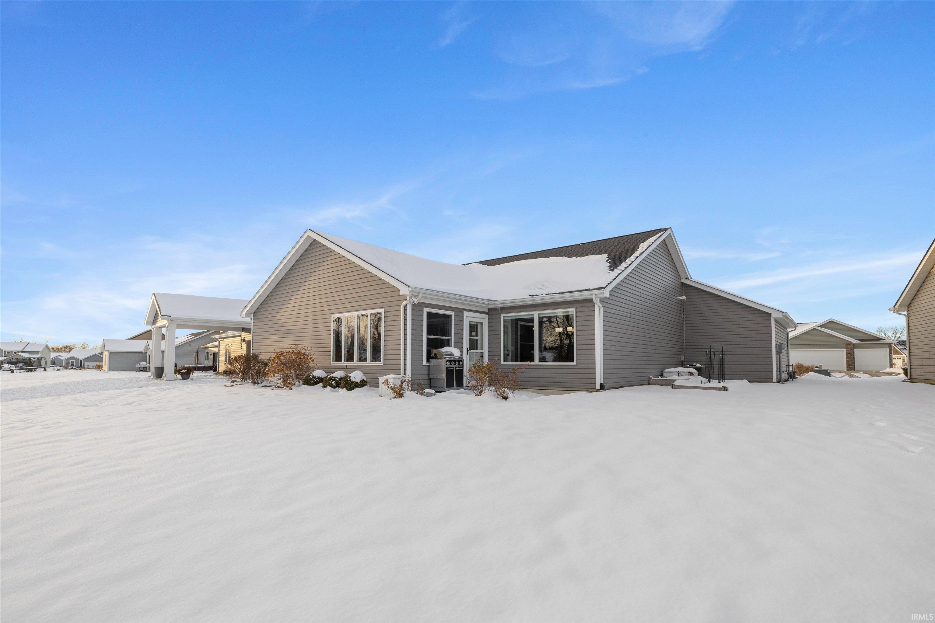 View of snow covered rear of property