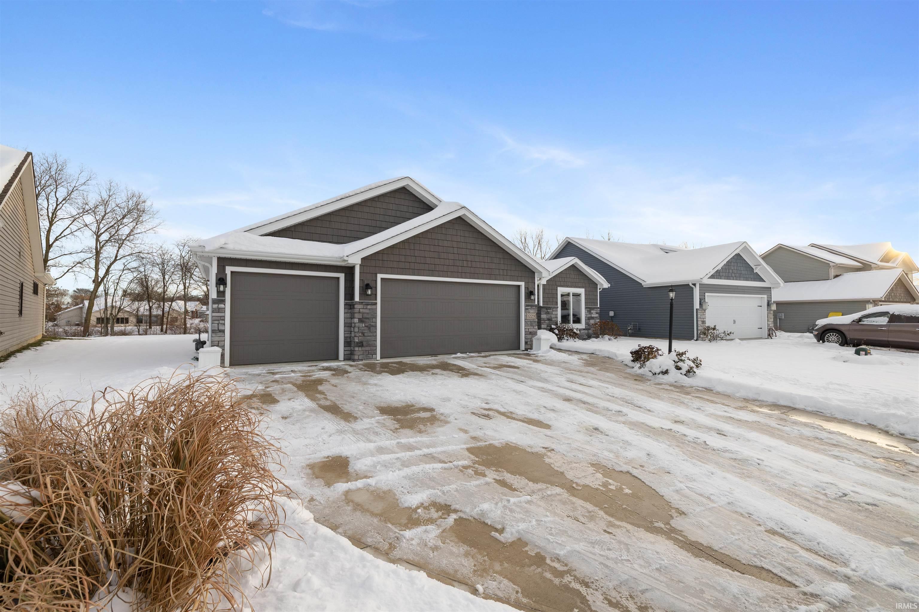 View of front facade featuring stone siding