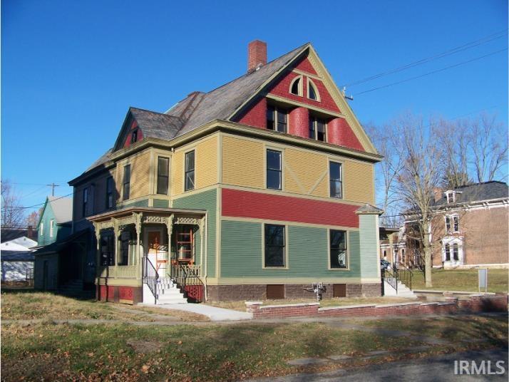 Victorian-style house featuring a chimney