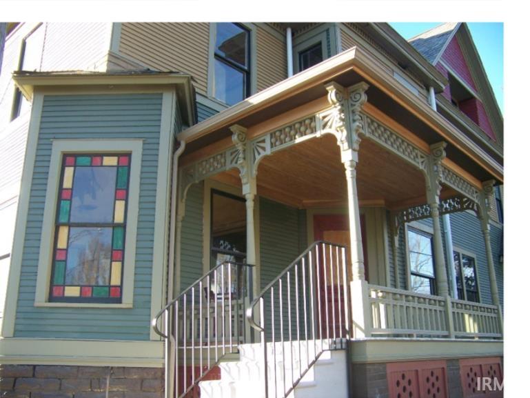 View of exterior entry with covered porch