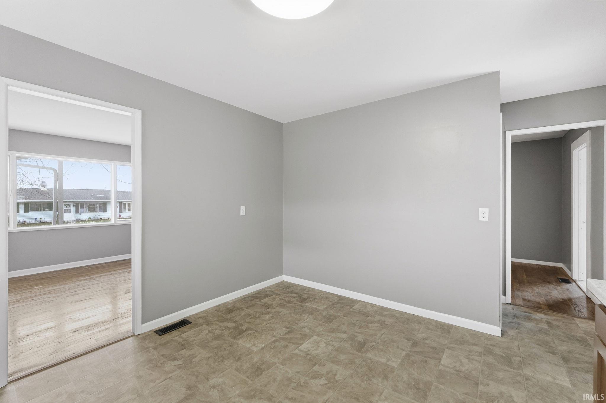 Unfurnished room with baseboards